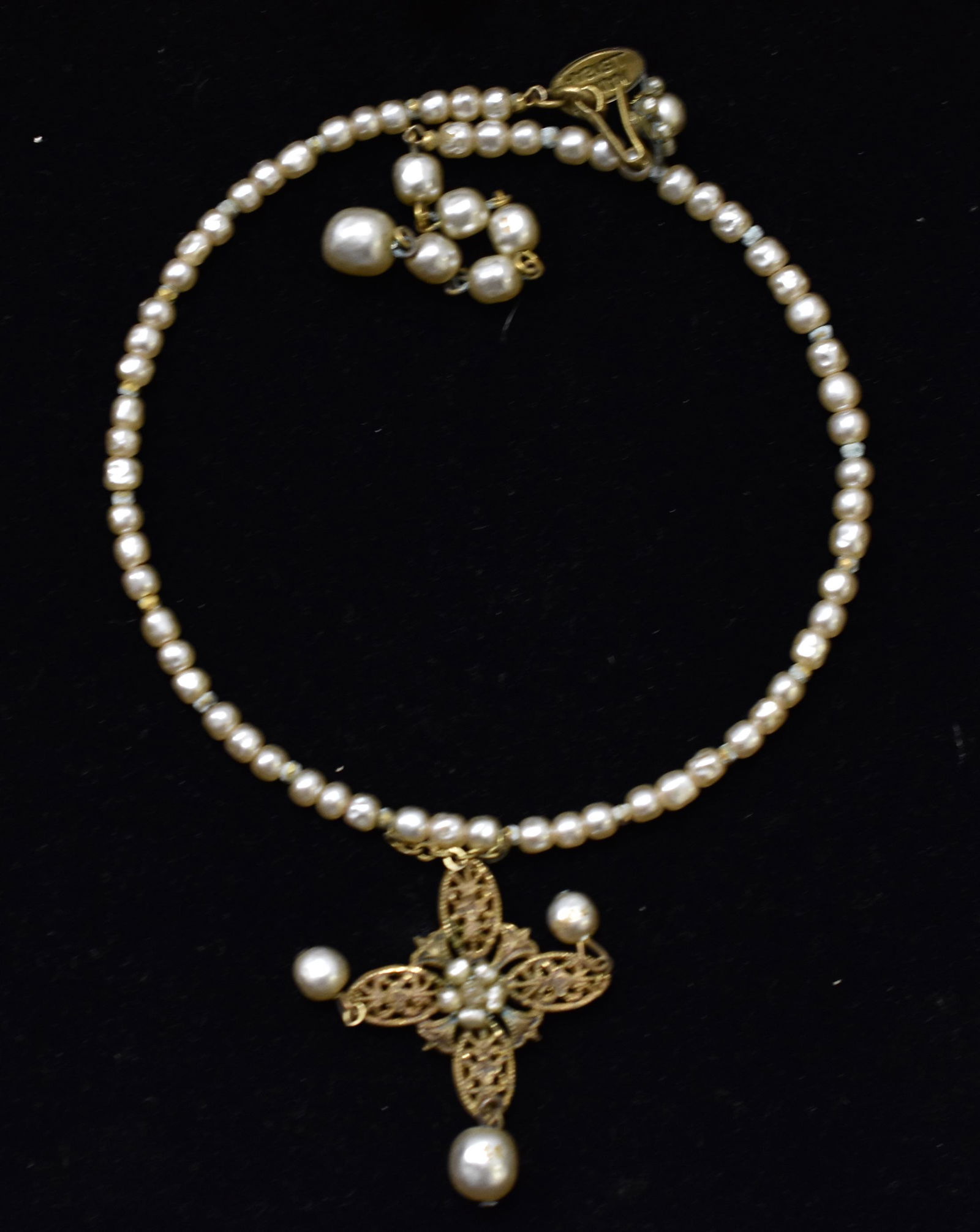 Vintage Miriam Haskell Necklace: Necklace is a pearl choker with a center cross and is signed on necklace and is tagged Miriam Haskell.