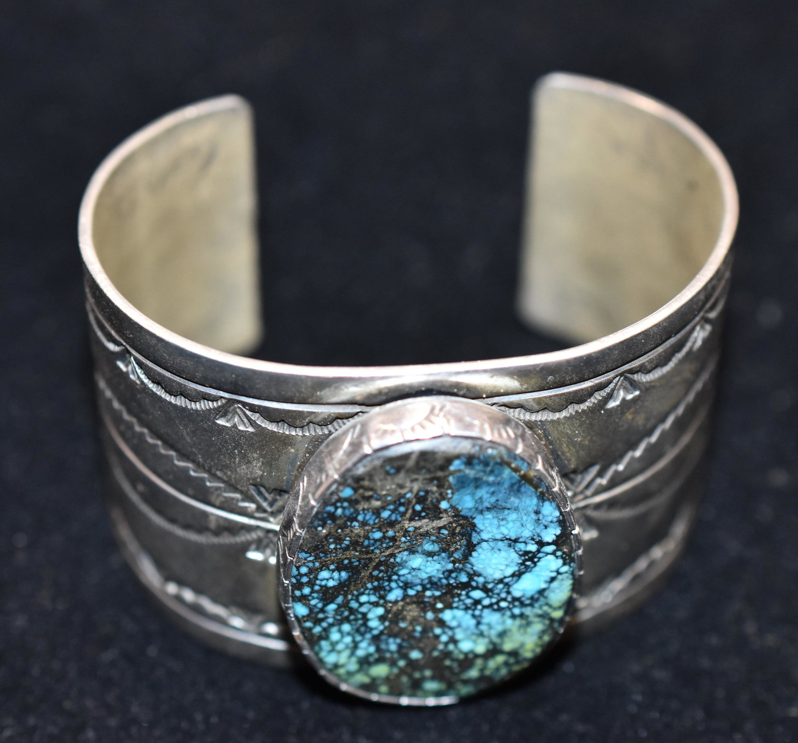Native American Turquiose and Sterling Cuff: Native American Turquiose and Sterling Cuff. ,Bracelet is signed by and is a Navajo style with a large central turquoise design.
