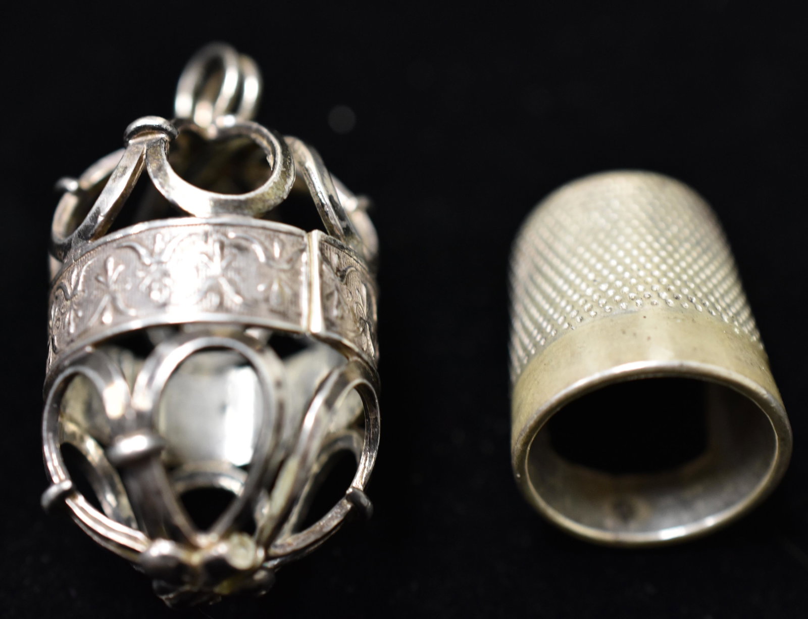 English Sterling Thimble and Case: Item is to be worn as a pendant and is a cage design with thimble inside.