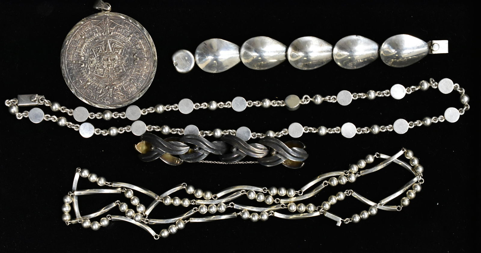 Mexican Vintage Taxco Sterling Grouping: Includes a very long aesthetic of beads and shaped necklaces and another round and ball shaped necklace. Also includes an Inca sun dial pendant and bracelet.