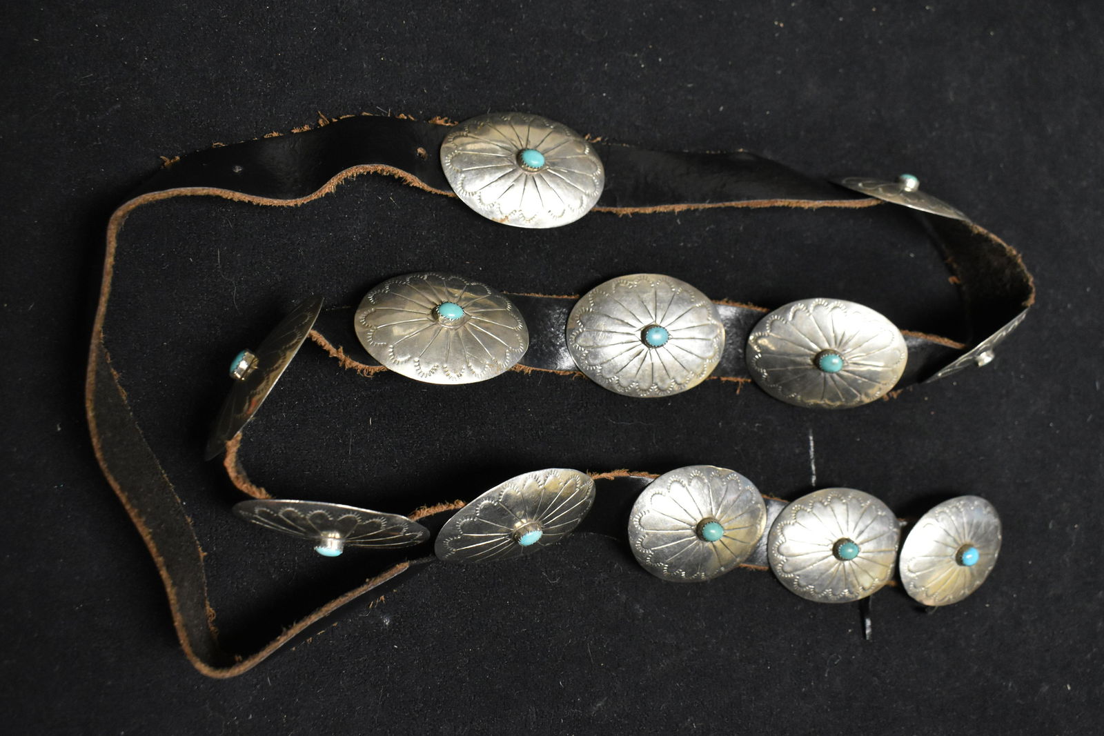 Antique Native American Concho Belt: The belt has 12 Conchos set with turquoise on a leather belt.