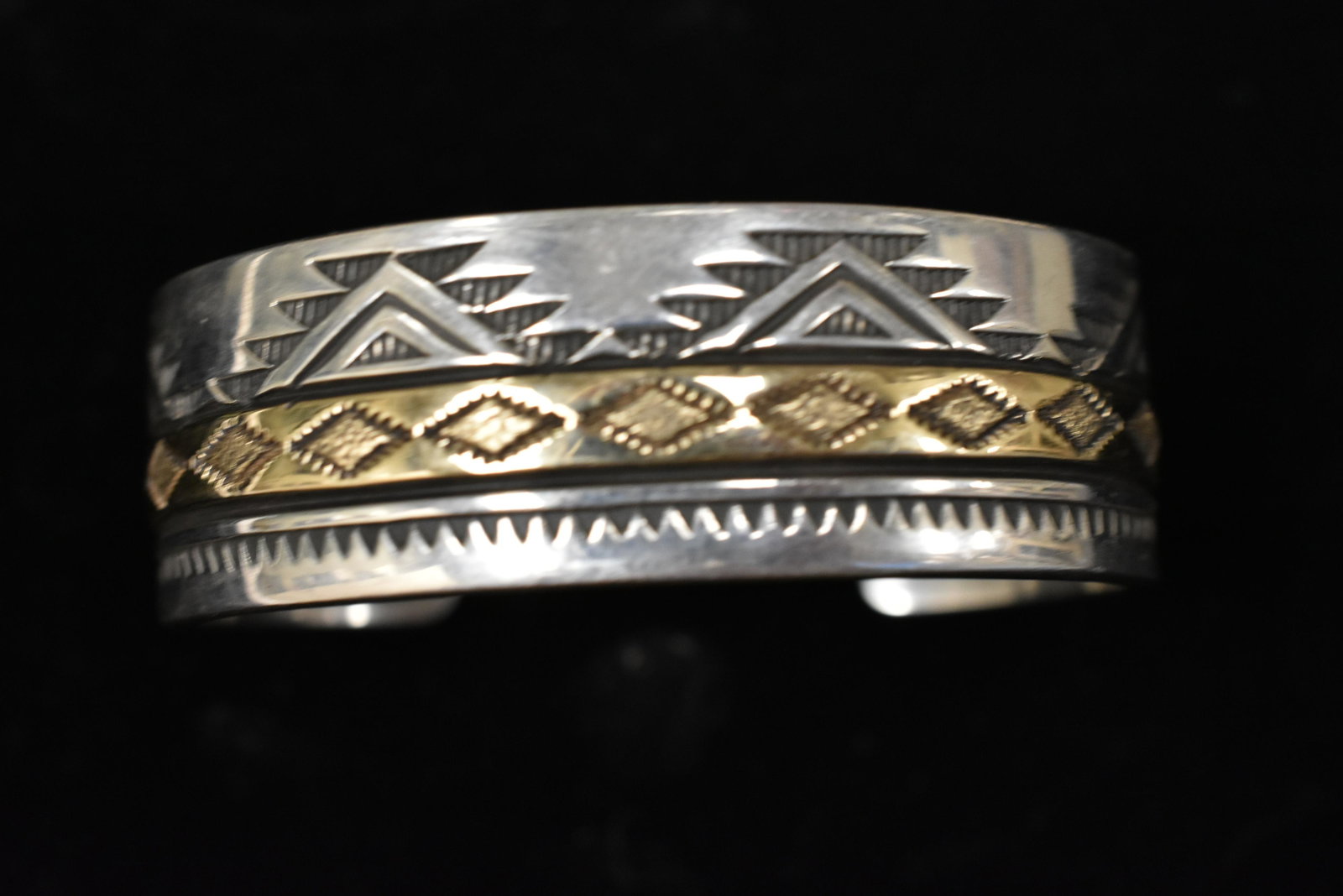 14K and Sterling signed Native American Cuff: The cuff is signed Lanier and has Navajo style engraving with a thick central 14K design.