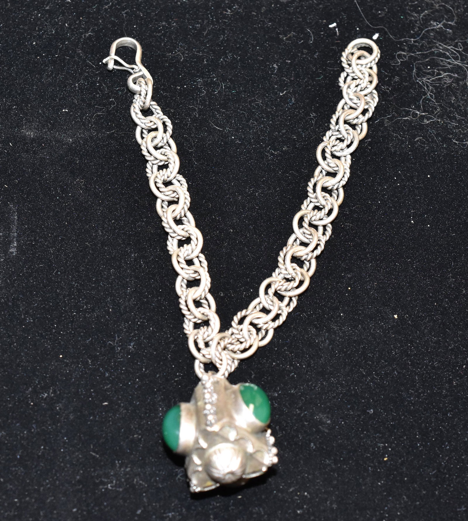 Antique .800 Silver Etruscan Charm Bracelet: It is curb-link with a large jade charm.