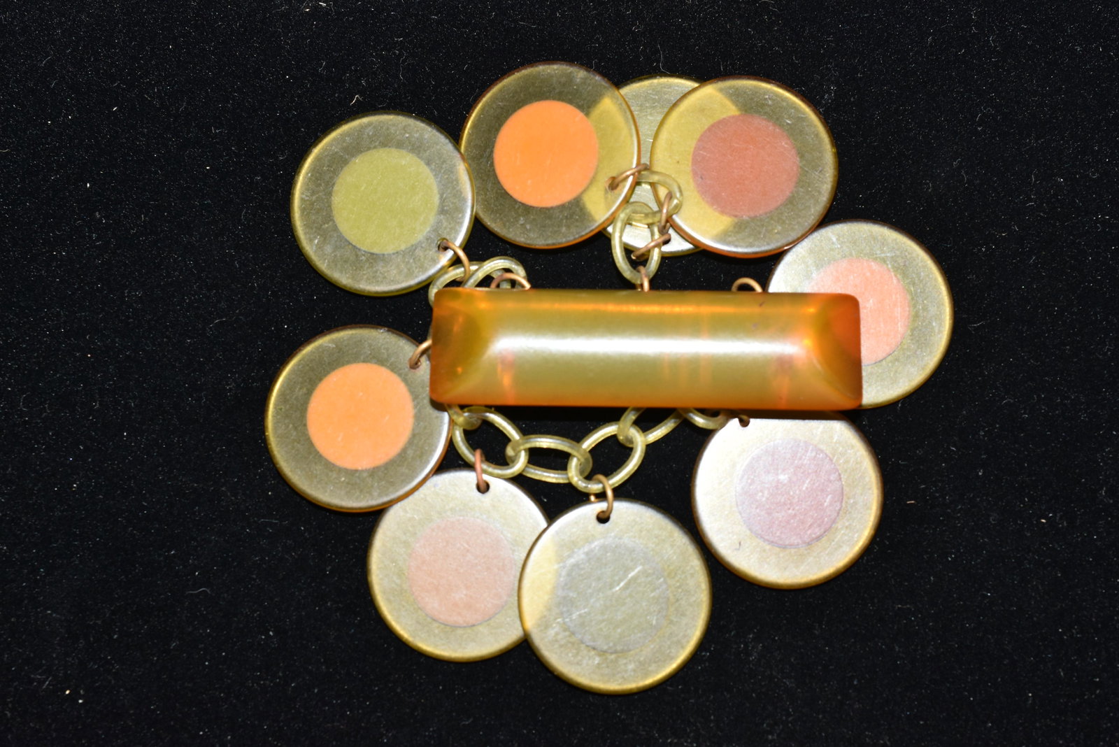 Vintage Bakelite Disk Charm Pin: It is butterscotch Bakelite with multiple hanging disks in orange and green,