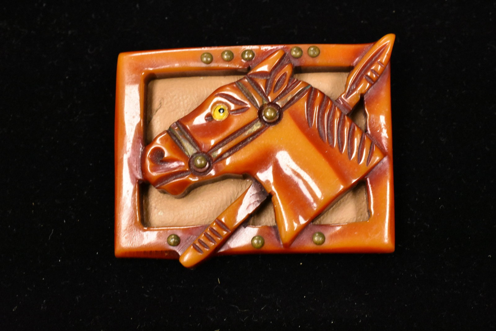 Vintage Bakelite Framed Horsehead Pin: The horse is in a square frame with a riding crop backed on leather. Note: slight rim chip.