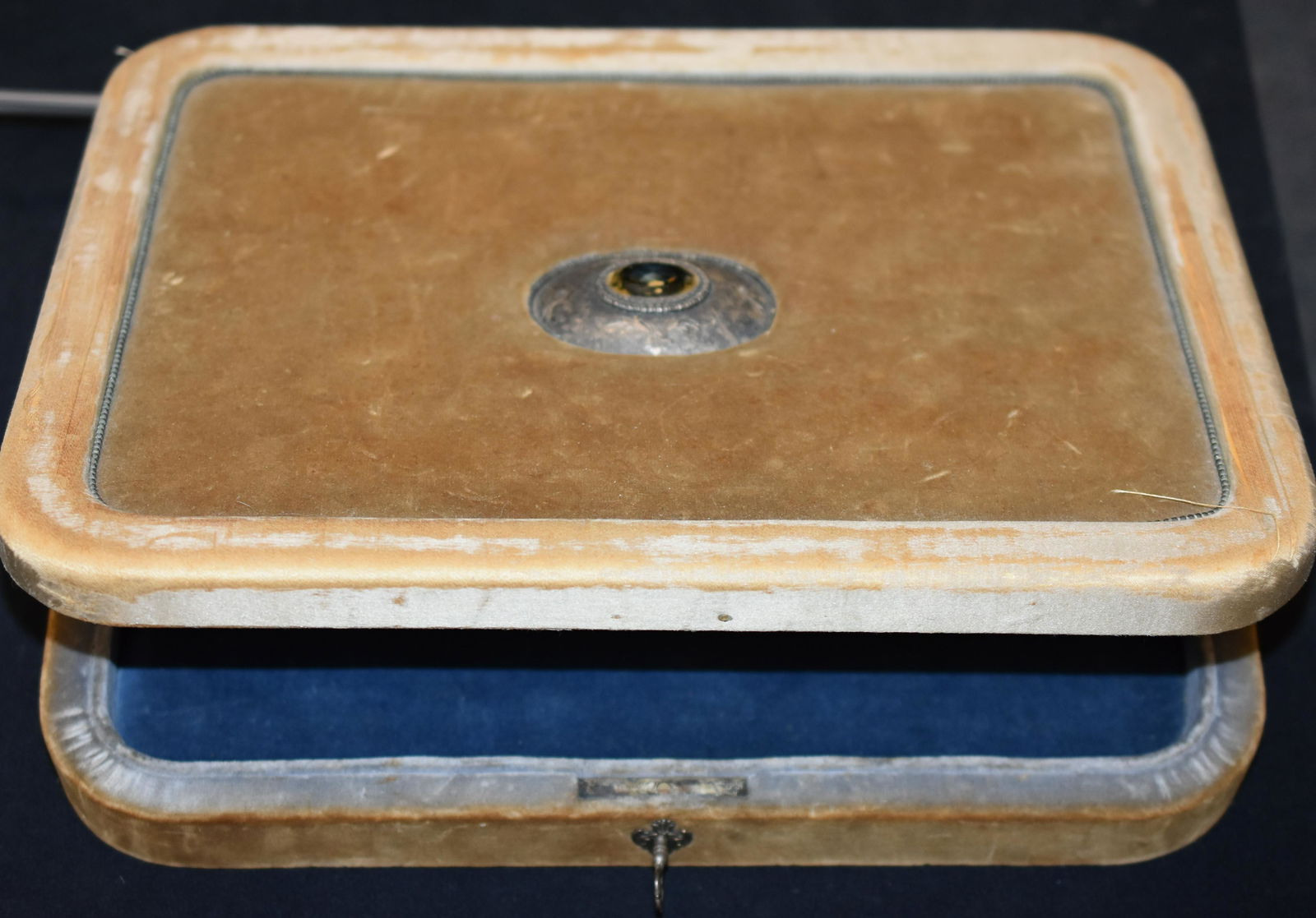 Box with Citrine and Sterling Center Medallion: The central sterling silver medallion in the box lid is etched with floral scrolls and has a large citrine quartz in the center. The box itself is tan velvet with worn silk borders and blue velvet int