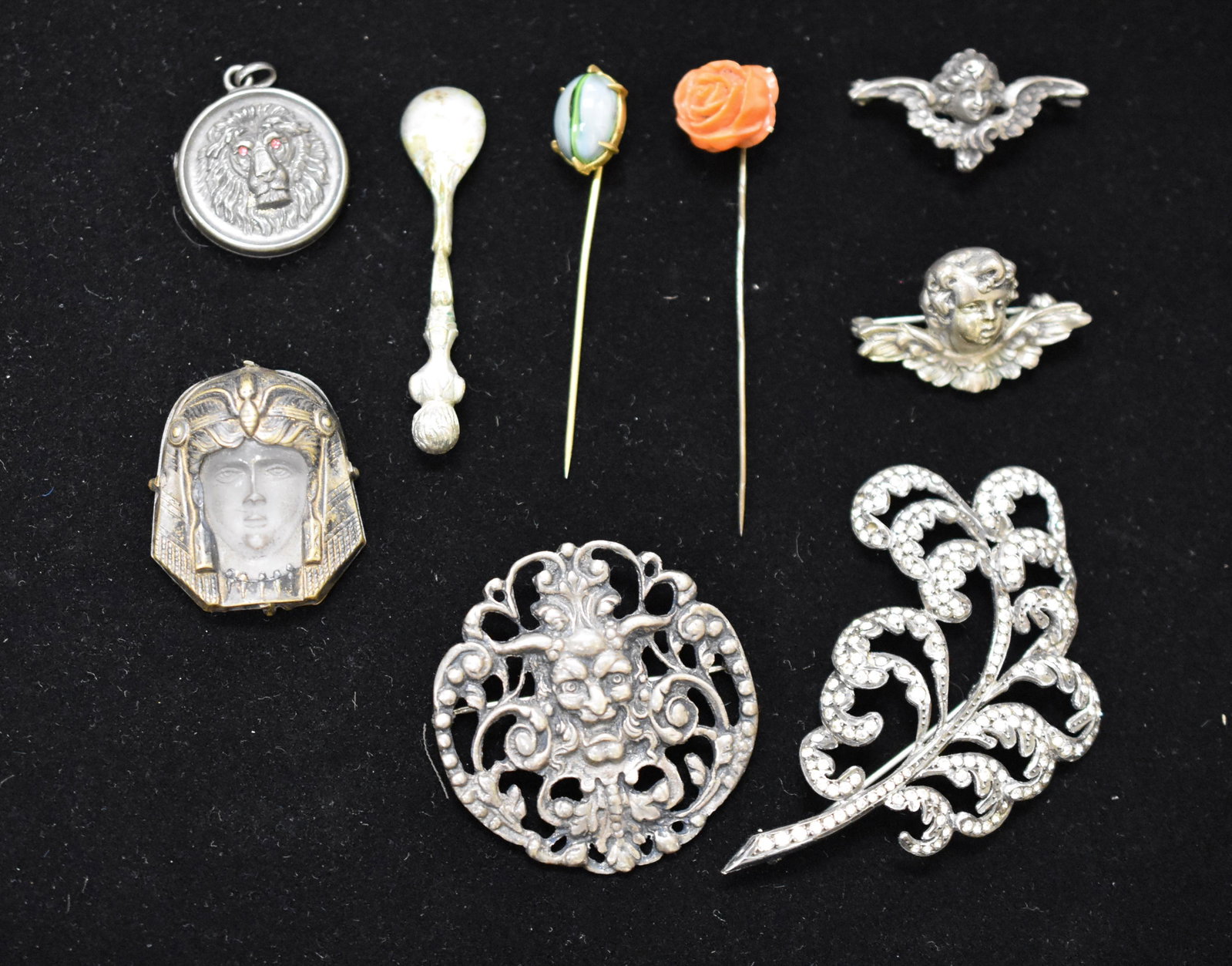 Victorian Sterling Collection: includes two sterling cherub pins, lion locket sterling, sterling centaur pin, Cleopatra sterling frosted glasstop of hat pin, 2 stick pins - fine carved coral rose and sterling feather pin.
