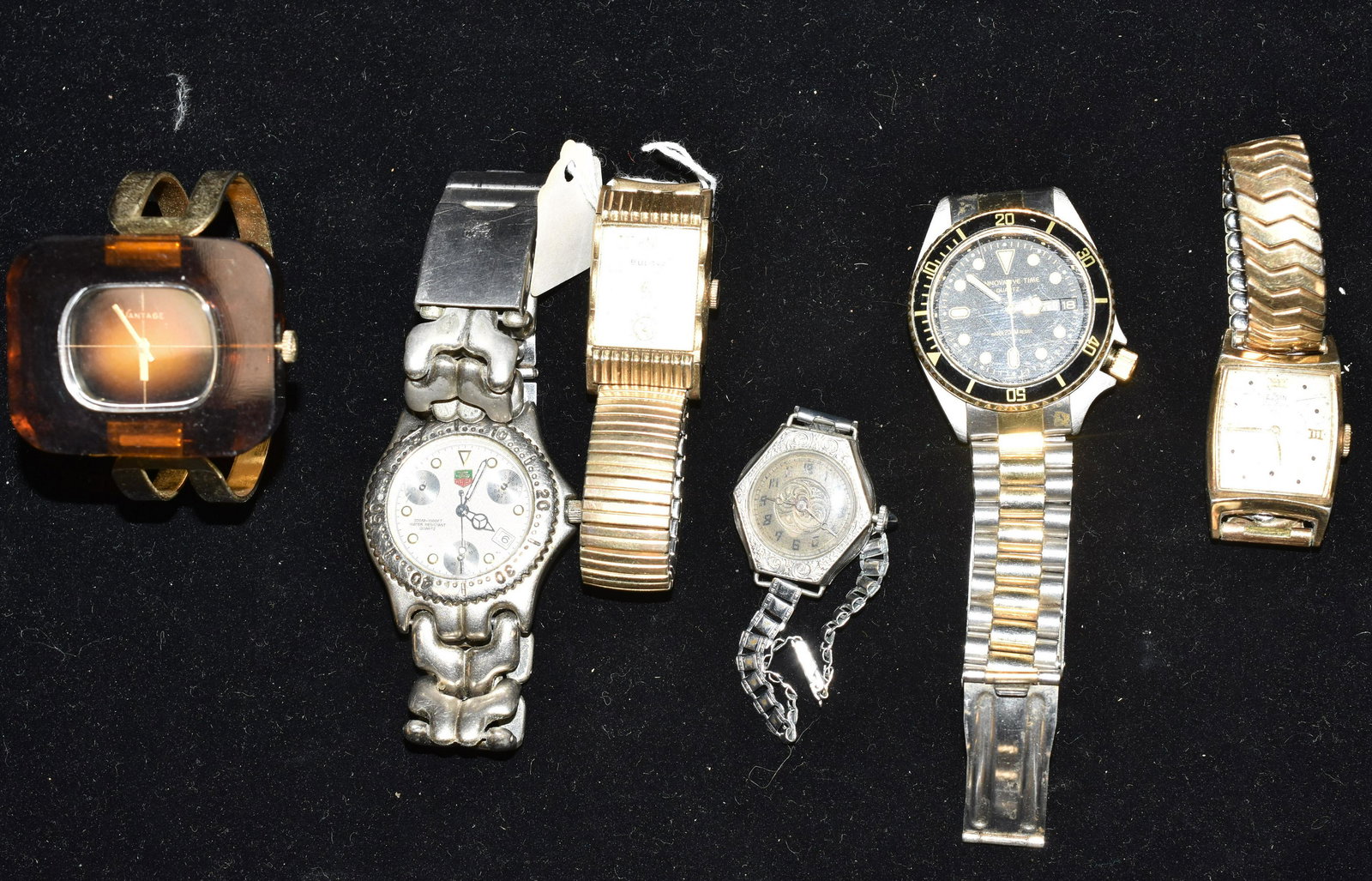 Vintage Wrist Watch Grouping: Including Men's Elgin Delux, Hamilton, a Tag Hauer divers watch and an Innovative time divers watch. ladies watches include a Vintage silver tone watch and a Vantage with Lucite body.