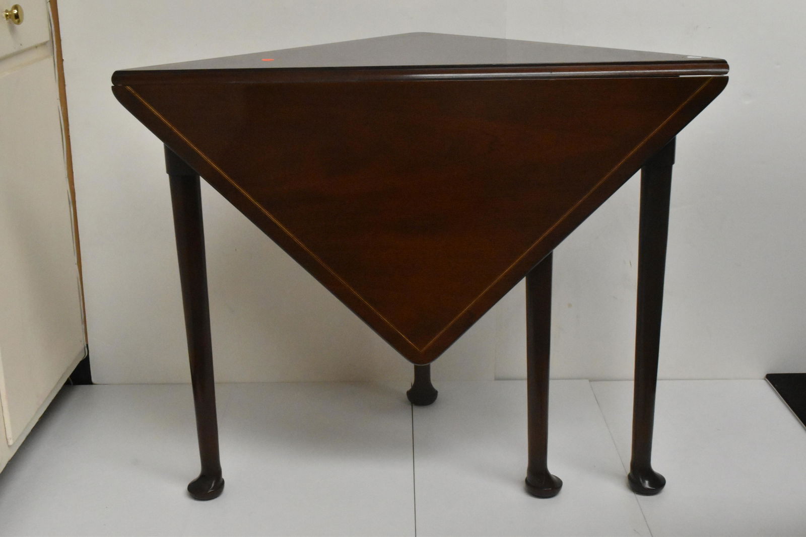 Triangular Mahogany Side Table: Item measures approx. 27" high x 34" x 34". table has a single drop leaf and stands on Queen Ann legs.