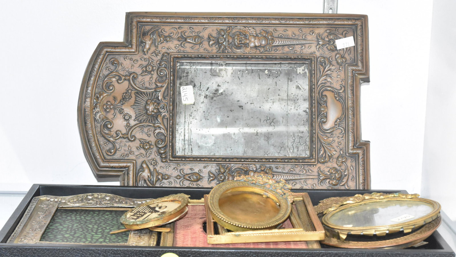 Grouping of Metal Victorian Picture Frames: Largest measures approx. 12"h and is a bronze wash over brass containing a small looking glass. Lot also includes seven small brass frames and a silver plated frame.