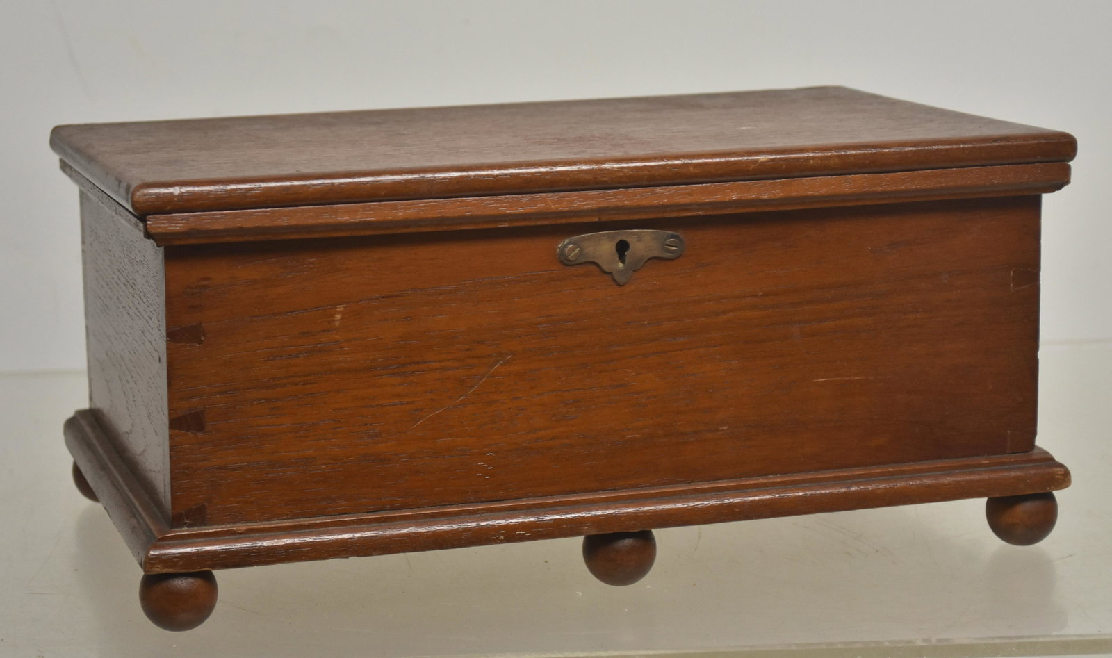 Miniature Six Board Dove Tailed Blanket Chest: Measures approx. 6"h x 13"w x 8"d. It is walnut construction, has original lock and hardware and stands on five ball feet..