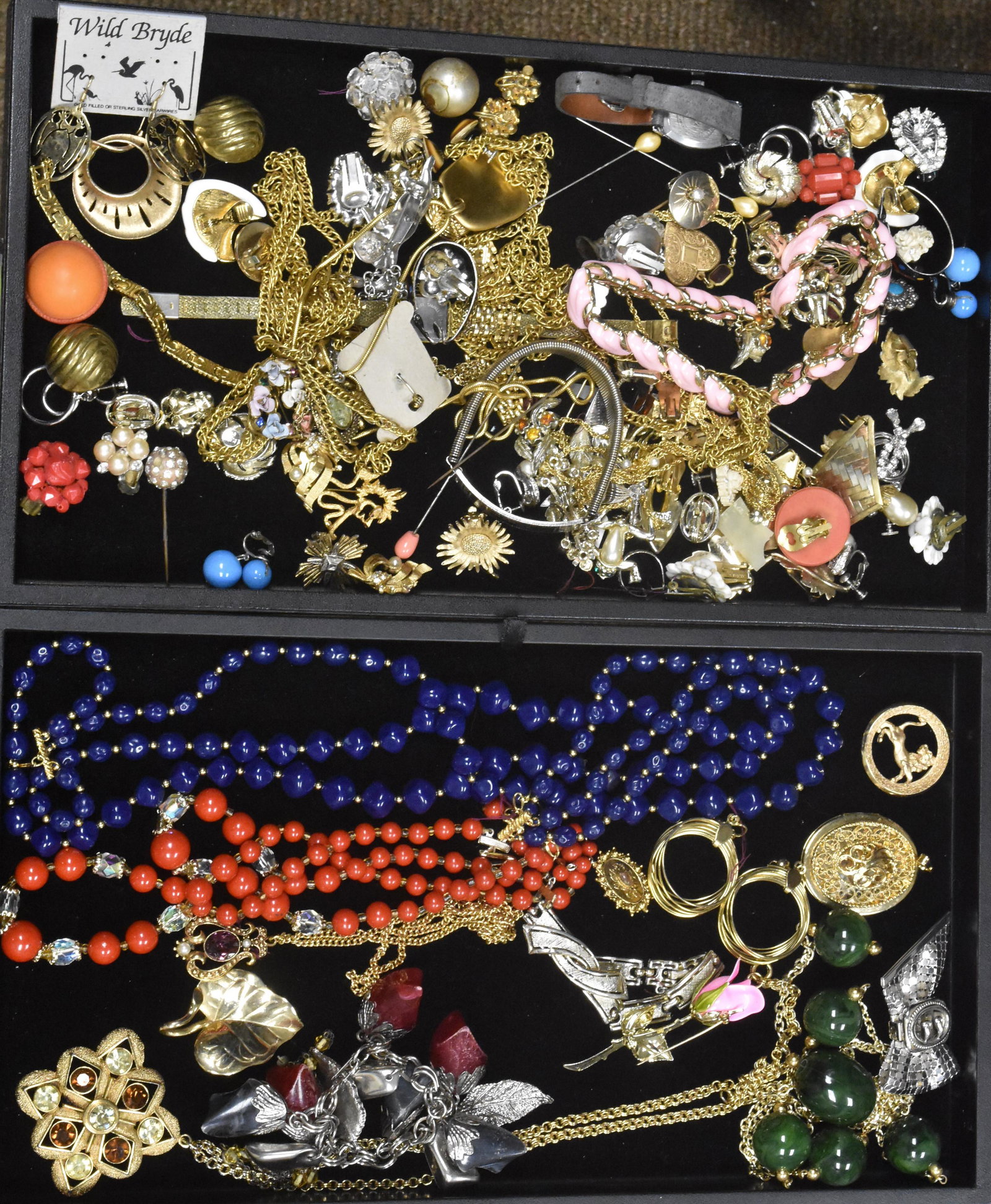 Two Trays of Costume Jewelry: Colorful beaded necklaces, necklaces with large gold tone pendants, a gold tone pendant with lemon and amber rhinestones marked "Coventry" and a large selection of earrings.