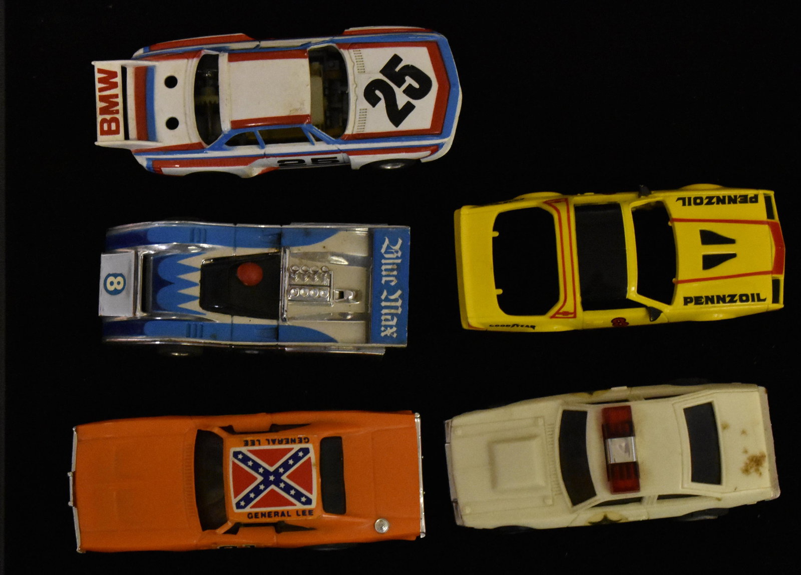 Four Vintage Slot Cars: Two "Ideal" slot cars dated 1981, two "Tyco" slot cars and an extra slot car body.