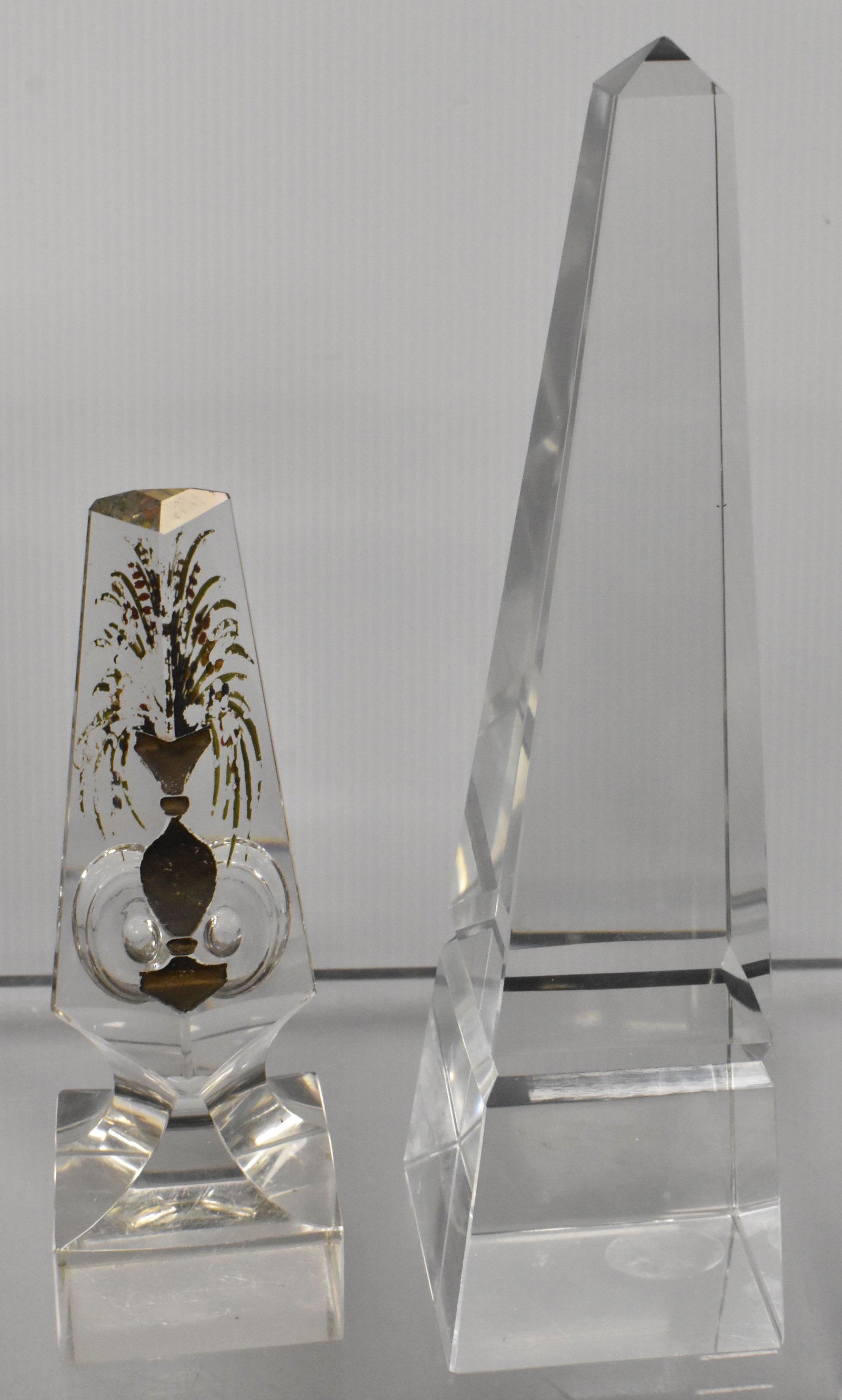 Two Obelisks: Larger measures approx. 10"h and is unmarked crystal. The second is in the form of a totem and has a small chip at one back corner.