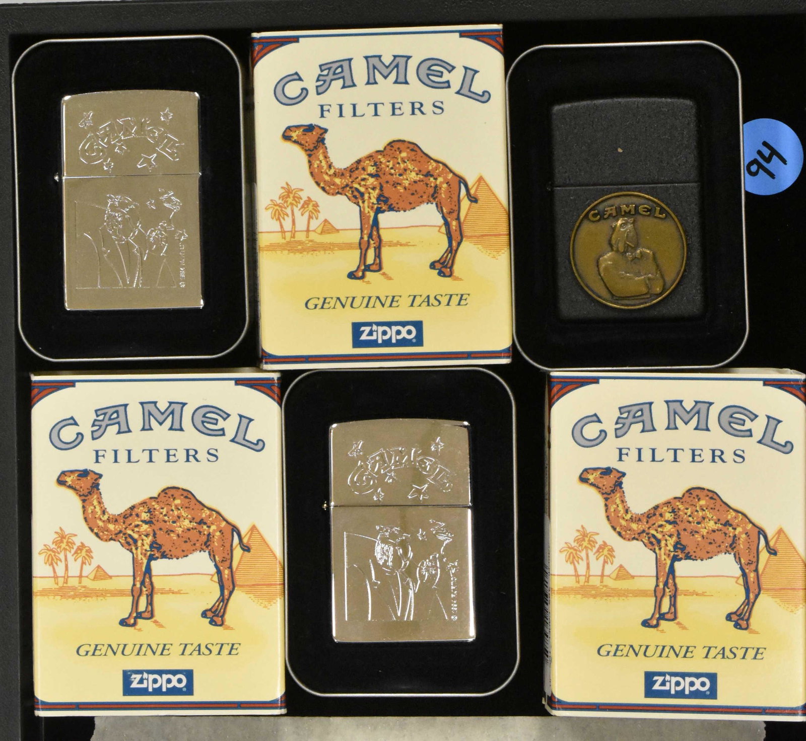 Camel Zippos (3): Three Camel cigarette Zippos with Smokin Joe, original tin and packaging, two metallic and one black/bronze color, all with Camel and Smokin Joe.