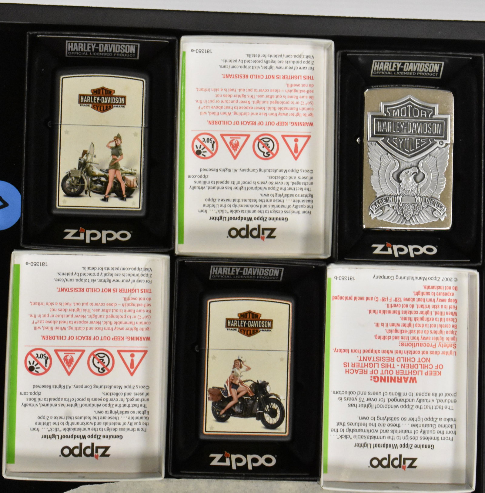 Harley-Davidson Zippos (3): Three Harley-Davidson Zippo lighters, orig box, images include two with vintage bike and girl, and one silver tone with eagle.