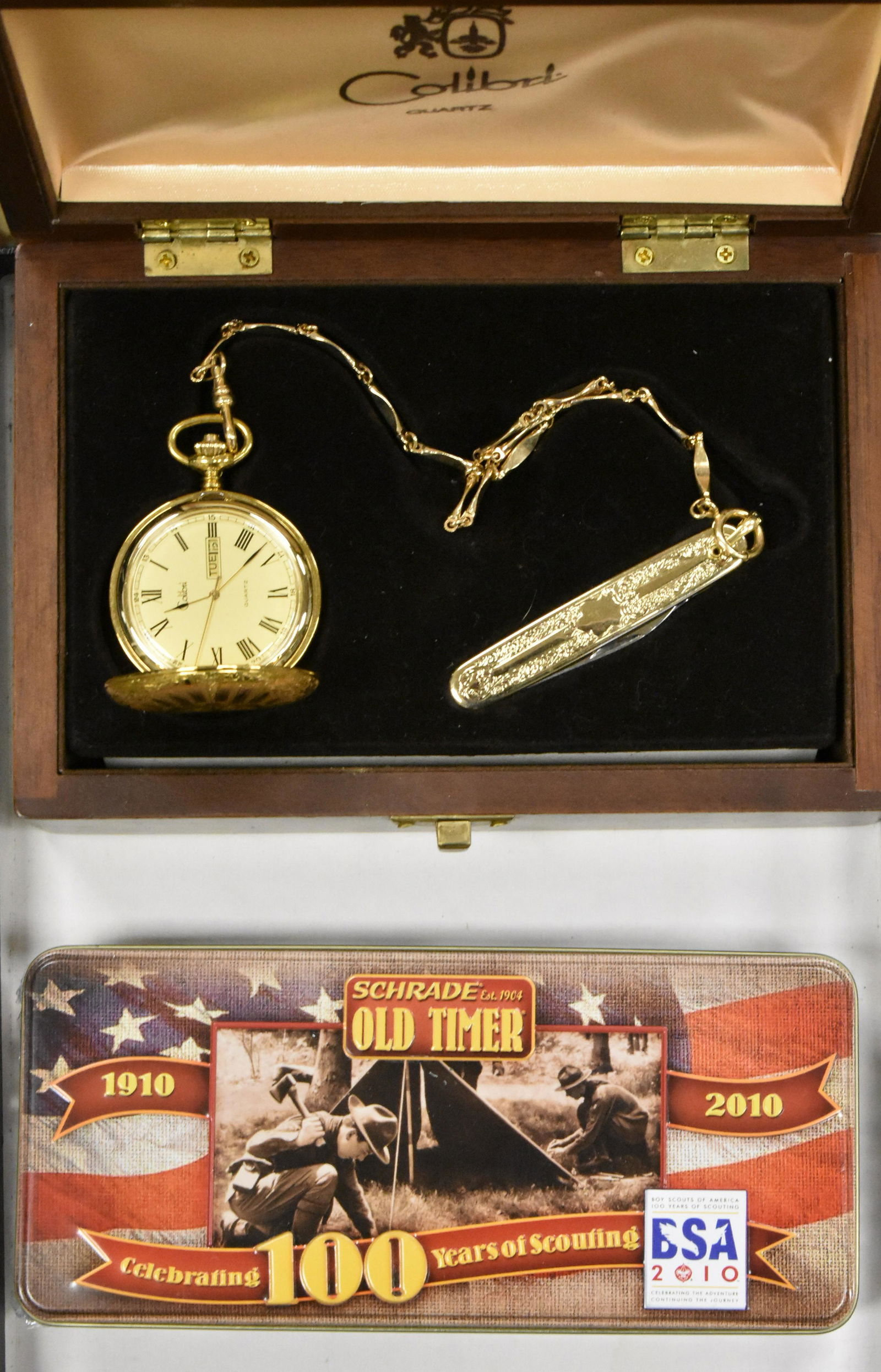 Two Souvenir Knives, one with Pocket Watch: Colibri Quartz Pocket Watch with Knife attached to fob and a Schrade Old Timer 100 Year Anniversary sealed in tin, Official Boy Scouts of America.