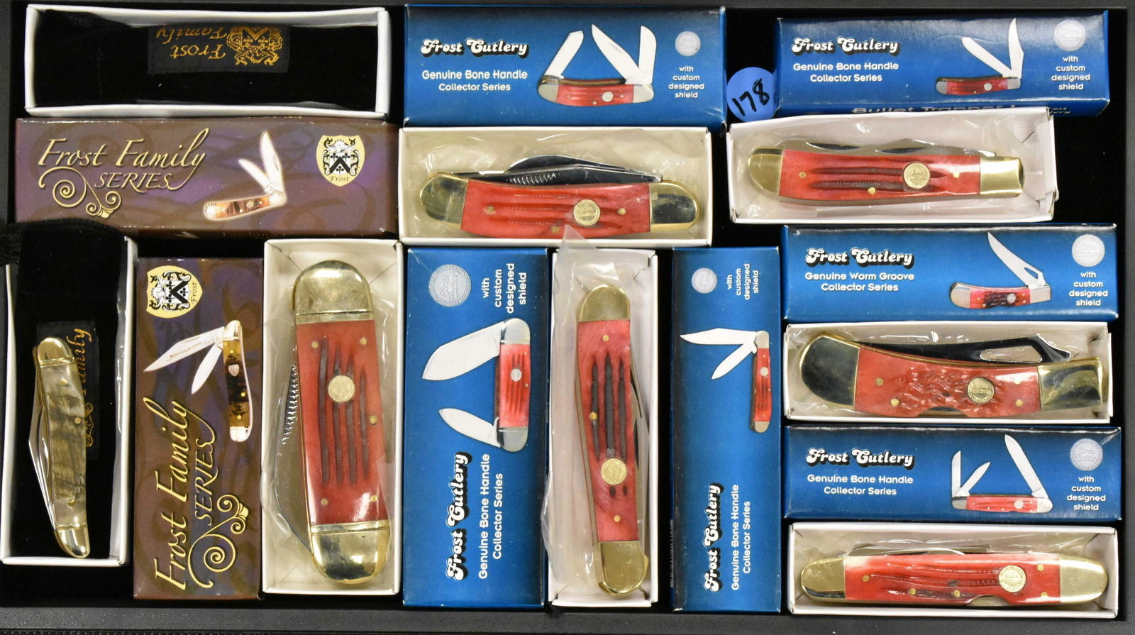 Eight Frost Cutlery Pocket Knives: Sunfish, Sow Belly, Copperhead, Lock Back Whittler, Bullet Trapper, Gator. All but 2 with Red handles