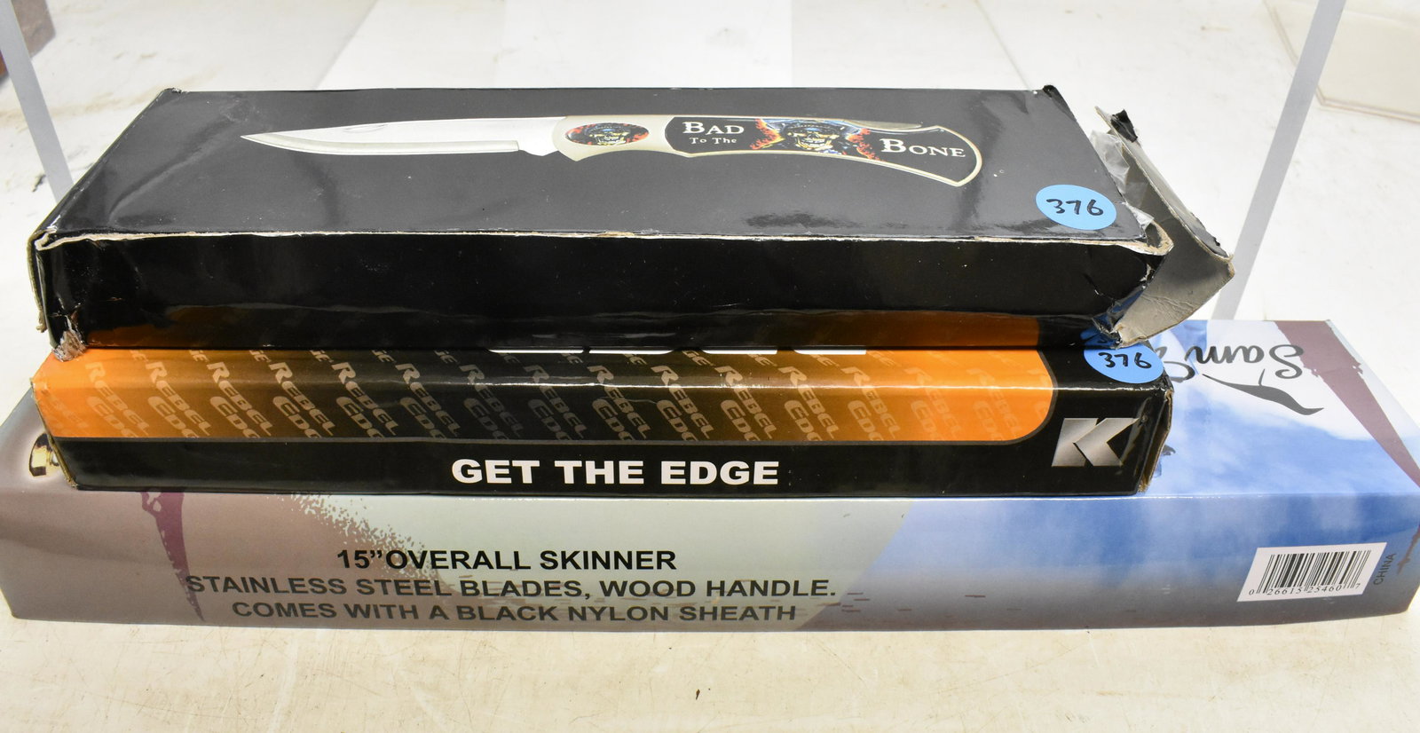 Three Novelty Knives: BudK Rebel Edge with Rebel to the Bone item#BK1023, a Tomahawk says Bad to the Bone XL1255, and a 15" overall Sam Houston II skinner model 16-952.