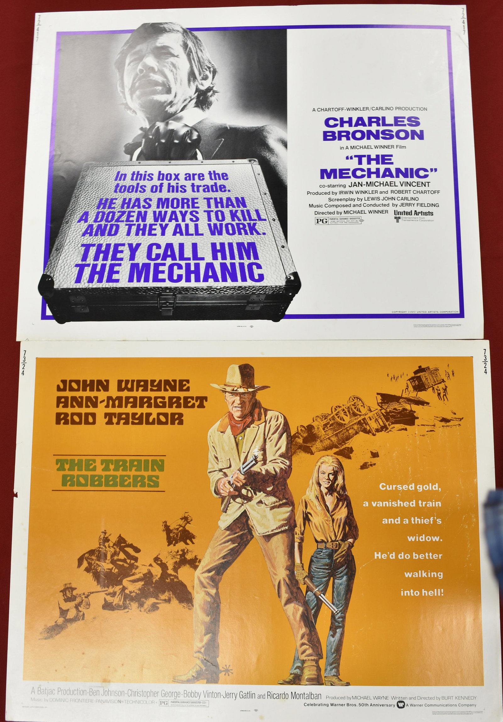 1970s Movie Posters, John Wayne & Charles Bronson: 1973 Warner Brothers "The Train Robbers" starring John Wayne and United Artist 1972 movie "The Mechanic" starring Charles Bronson. Approx 22" x 28"