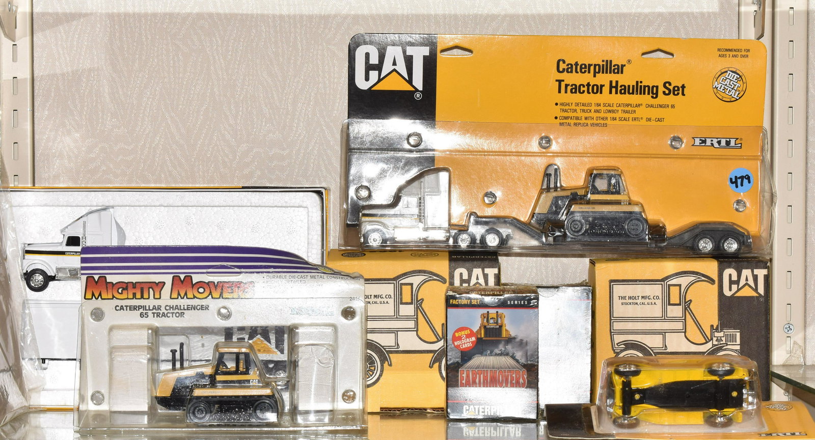 6 Ertl CAT Vehicles and More: Including Cab with trailor model 7712, tractor hauling set model 7711, 1932 panel delivery truck model 7707, mighty movers challenger 65 tractor model 2415, 2 1905 delivery car banks model 7709. Also