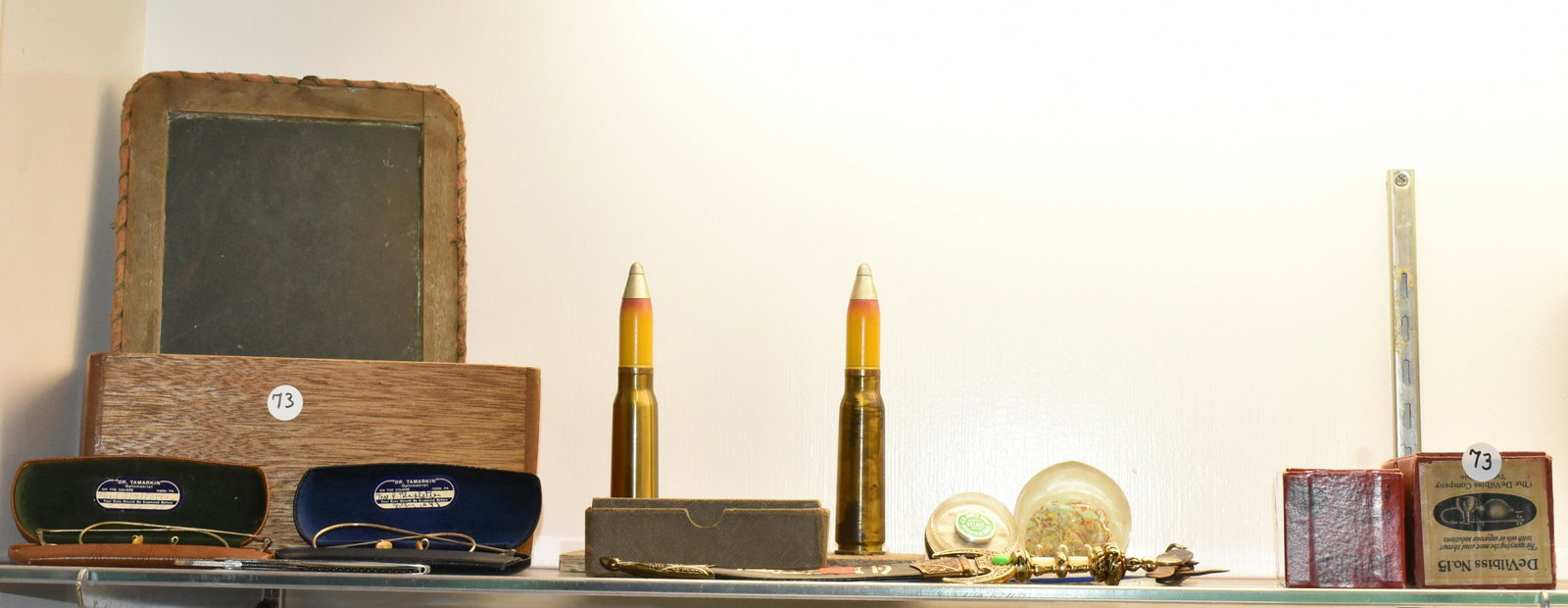 Eclectic Desk Top Grouping: Two pair of vintage eye glasses, a trench art pen holder, a razor and sharpener, a Boy Scout knife and other items.