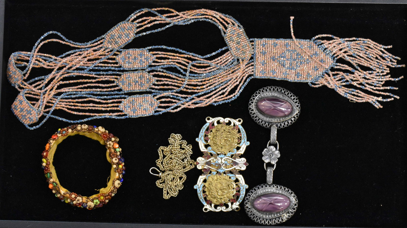 Antique and Vintage Jewelry: Including a Victorian champleve enameled Medusa head buckle, a glass beaded flapper necklace, a glass beaded flapper bracelet and a buckle with large purple stones.