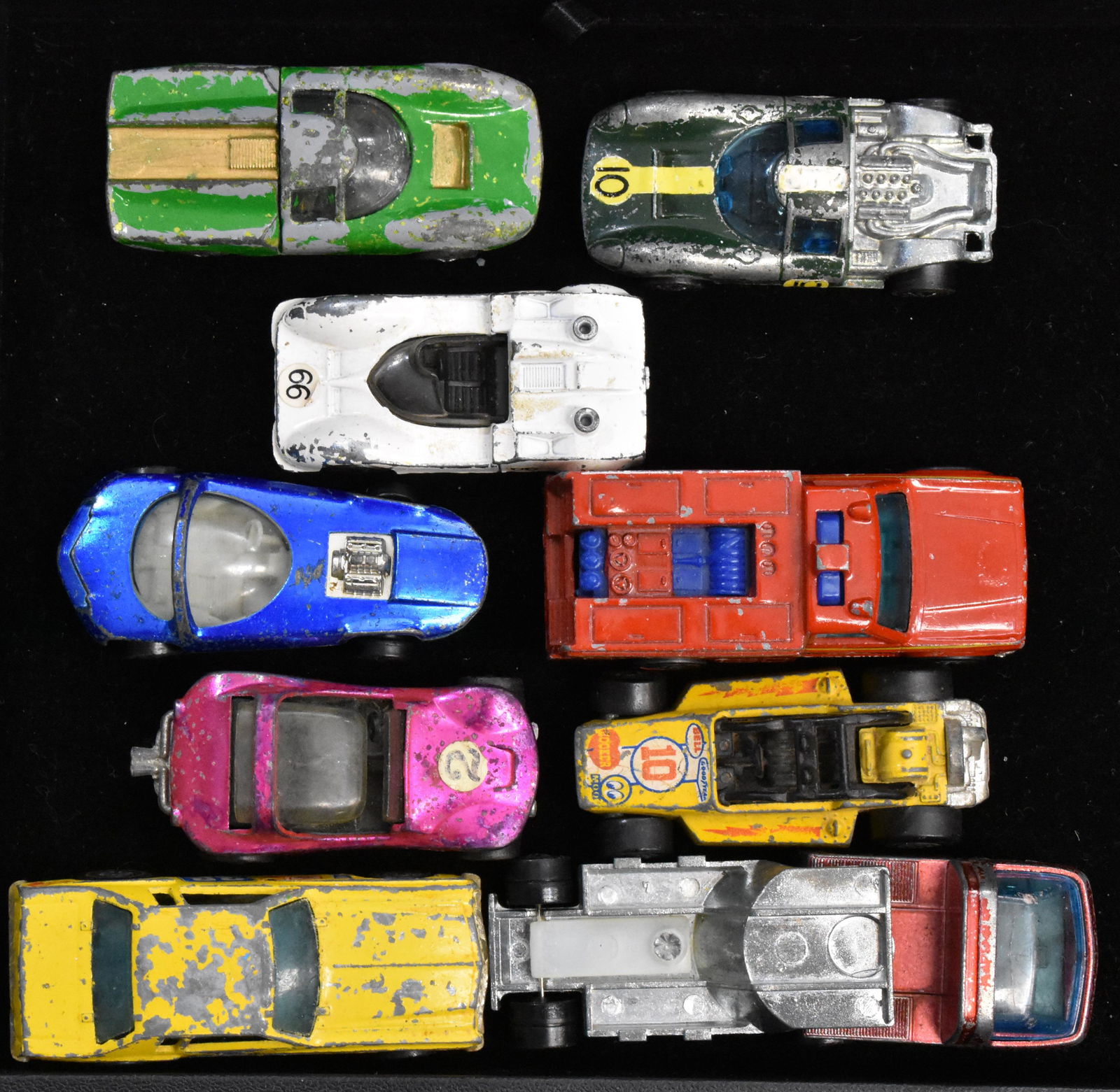 Grouping of Hot Wheels Red Line Vehicles: Nine hot wheels Red Line vehicles including a pink sand crab dune buggy, a blue silhouette and others.