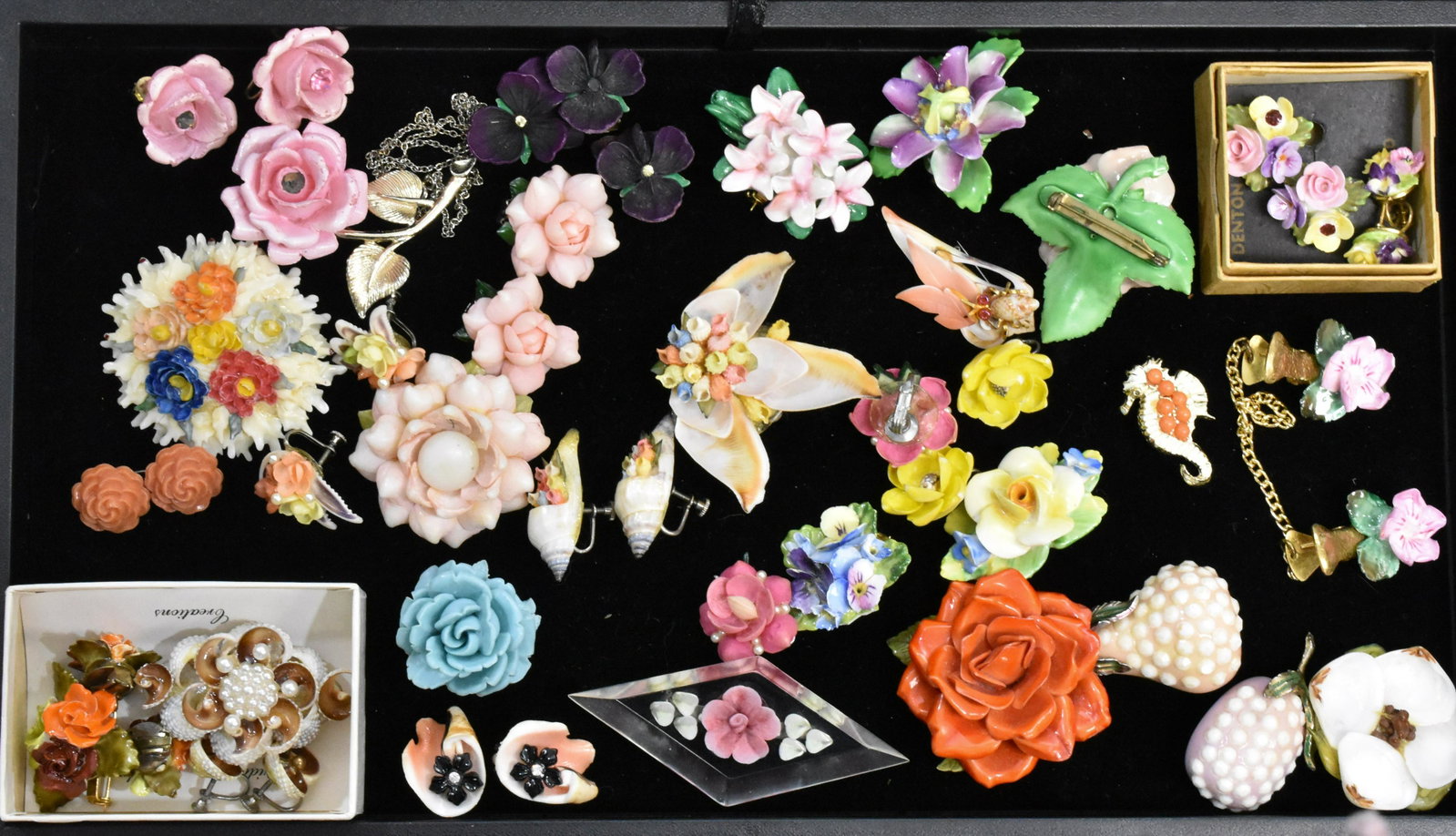 Porcelain, Shell and other Jewelry: Floral pin marked "Cara Chine Staffordshire Made in England", a porcelain sweater clip, a selection of shell jewelry and some plastic floral jewelry.