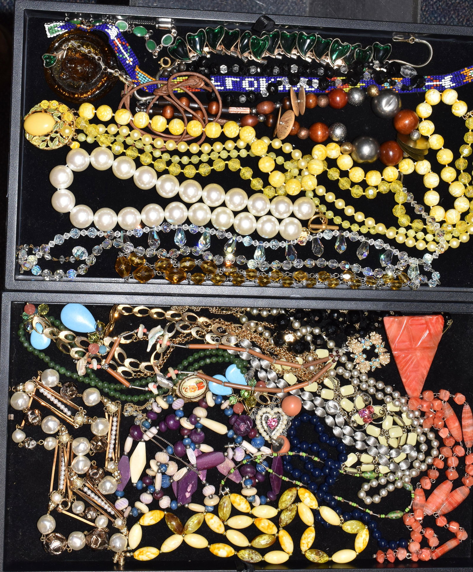 Two Trays of Costume Jewelry: Including a lemon yellow beaded necklace, two Aurora Borealis necklaces, a red stone necklace with a triangular pendant and many other pieces.