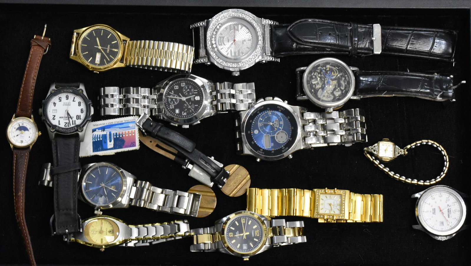 Collection of Wrist Watches: Men's watches include a Swiss Army diver's watch, a Seiko with day and date, an Icestar and others. Lady's watches include Cristian Lay, an Omax with a Ferrari symbol, a Kenneth Cole Reaction and a vi