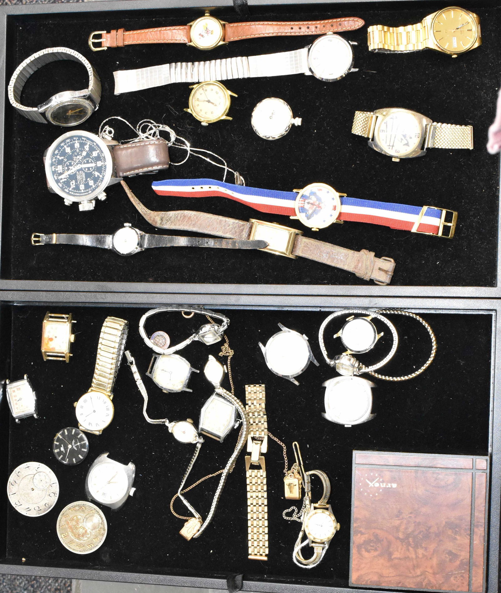 Two Trays of Watches and Movements: Including a Lorus Mickey Mouse watch, a Citizen anti-magnetic, a Seiko quartz with day and date, an oversized Invicta diver's watch, a vintage Gotham, other watches and various movements.