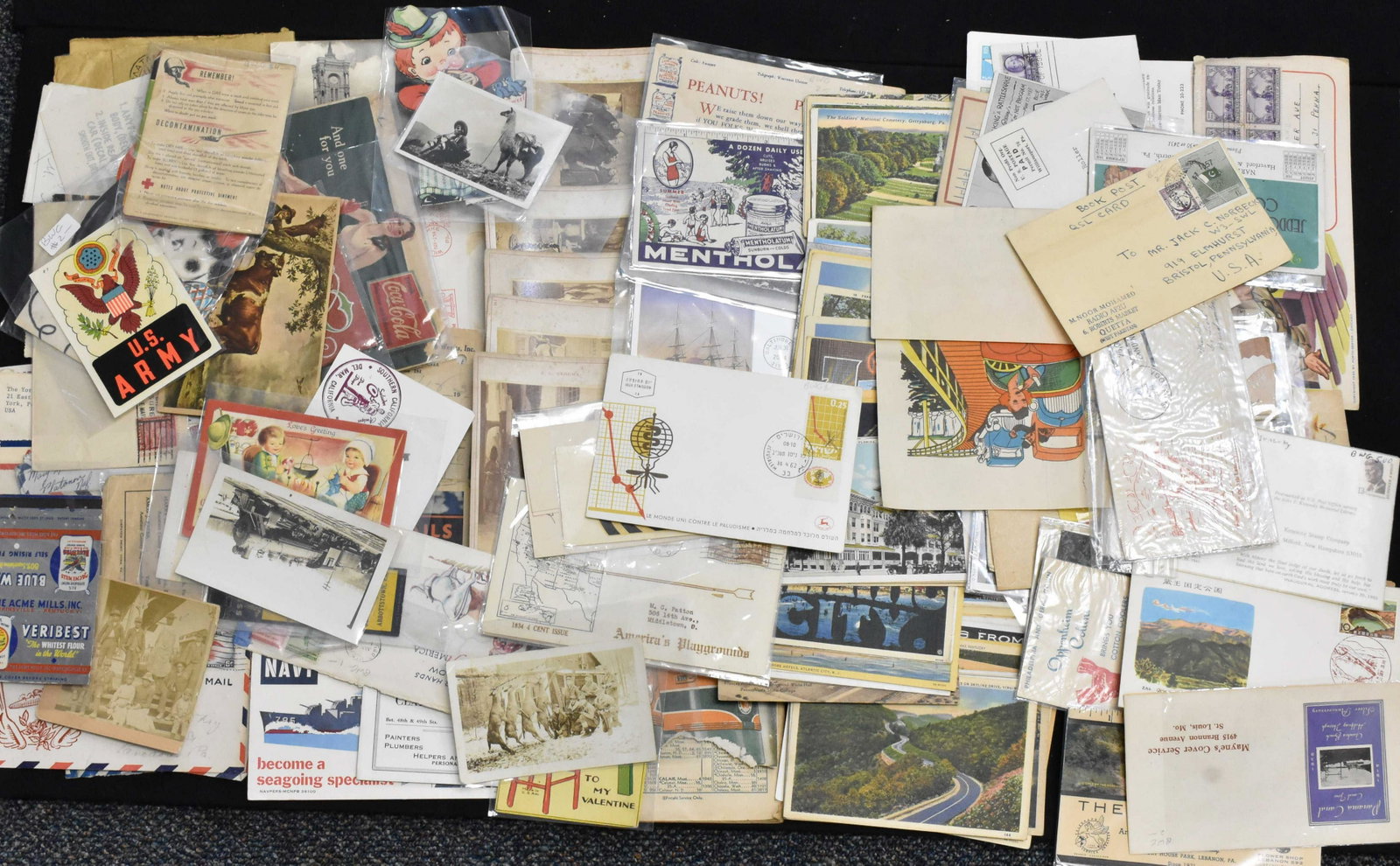 Vintage Postcards and Ephemera: Includes a selection of mid 20th century travel cards, 1930's military envelopes with stamps, a 1945 PRR travel table booklet, a patriotic photo of children dated 1904 and a selection of vintage adver
