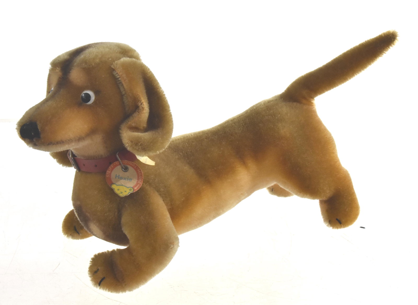 Steiff "Hexie" Dog: Measures approx. 13" in length. It has original ear tag and button and the paper name tag on the collar.