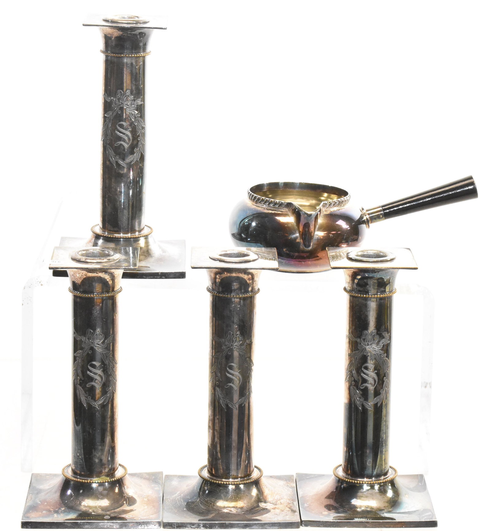 Pairpoint Silver Plate Grouping: A matched set of four candlesticks measuring approx. 7 1/2"h each and a gravy server or infant feeder. All items are marked "Pairpoint".