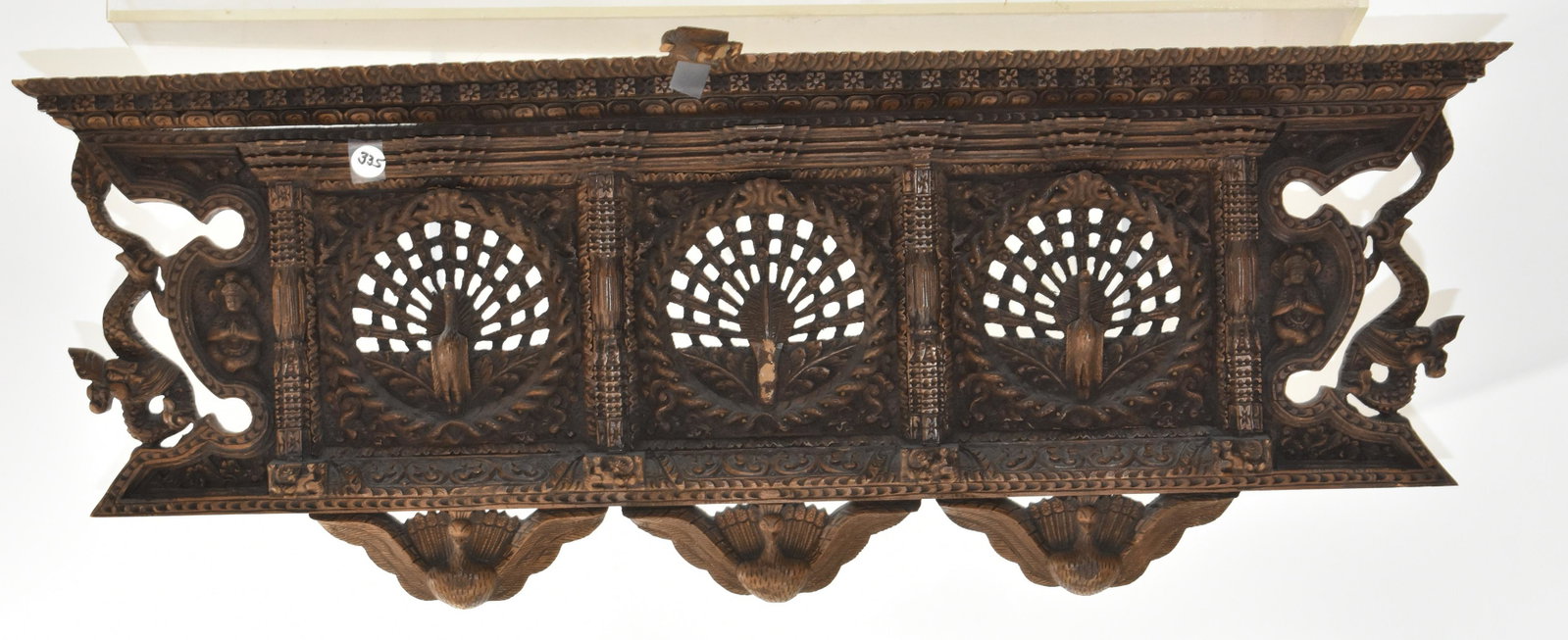 Heavily Carved Wooden Asian Peacock Panel: Measures approx. 12"h x 33"w. Item is a muli layered carving with dragons and a Buddha on each side. It has three inset panels with large peacocks (central peacock is damaged) and is constructed of a 