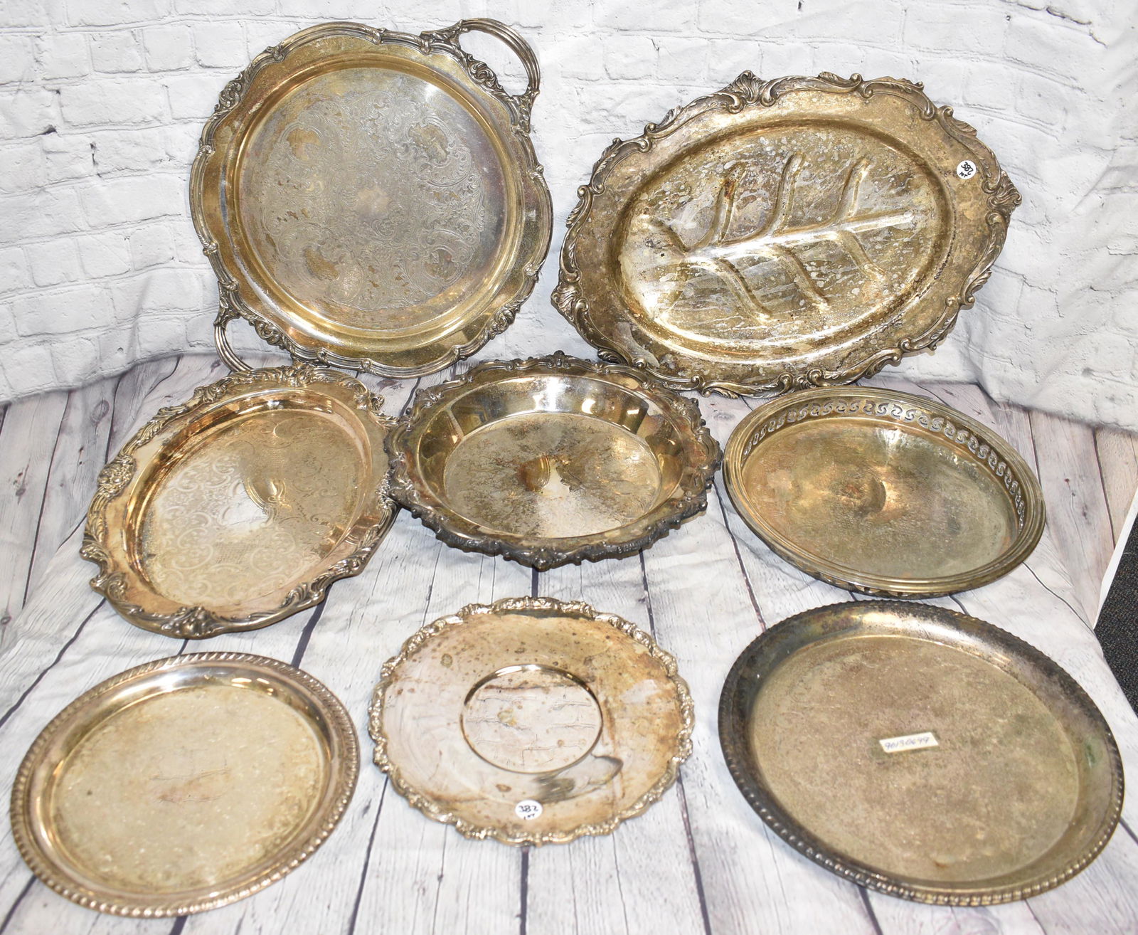 Grouping of Silver Plated Trays & Plates: Largest measures approx. 19" in length. There are various styles. Six trays and two plates