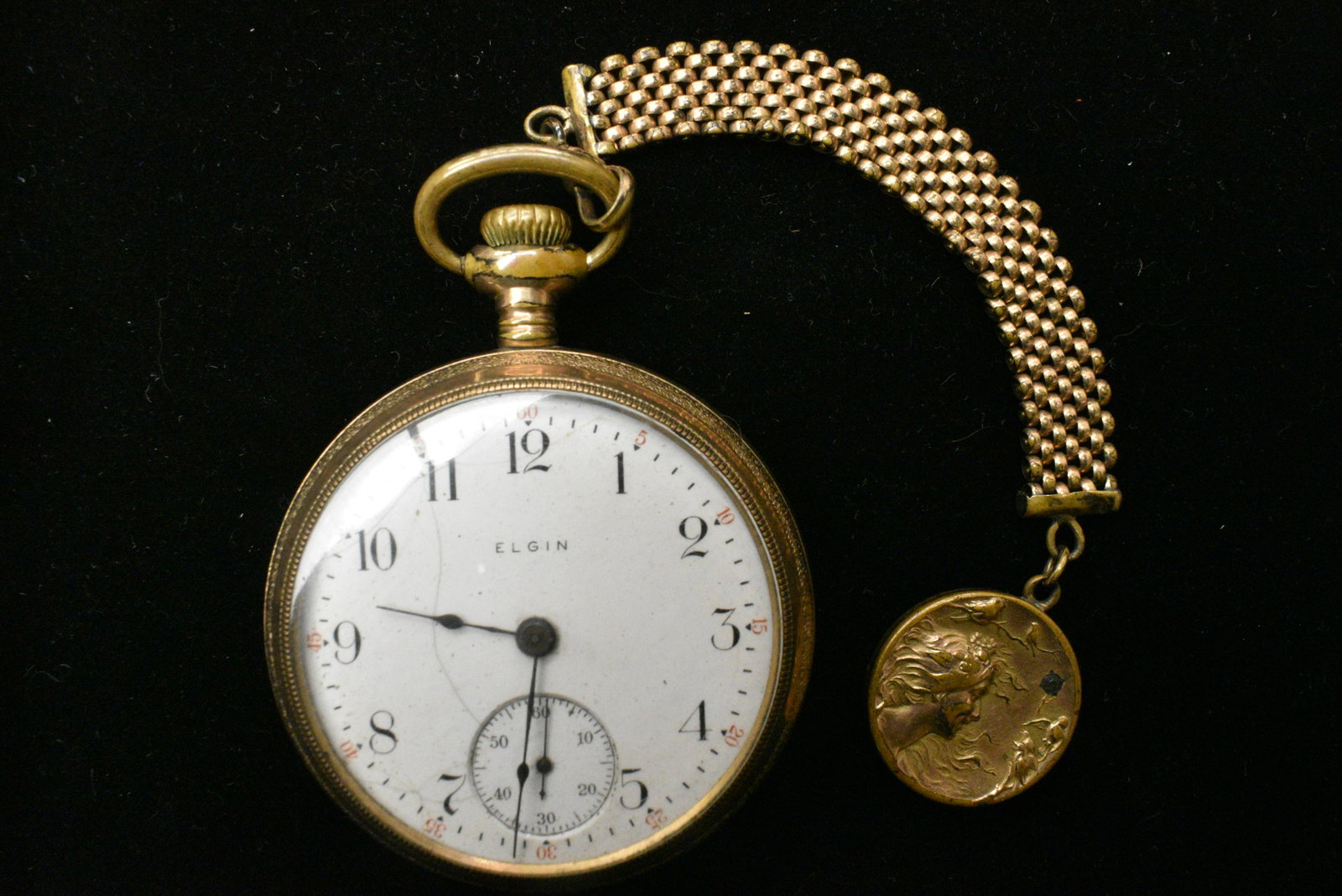 Antique Elgin Pocketwatch and Fob: Gold filled elgin case with with second-hand dial, screw on back, and art nouveau lady on Fob.