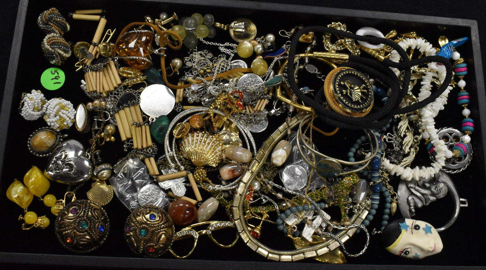 Large Jewelry Assortment: A musical charm bracelet, a rhinestone sweater clip and various necklaces and pins.