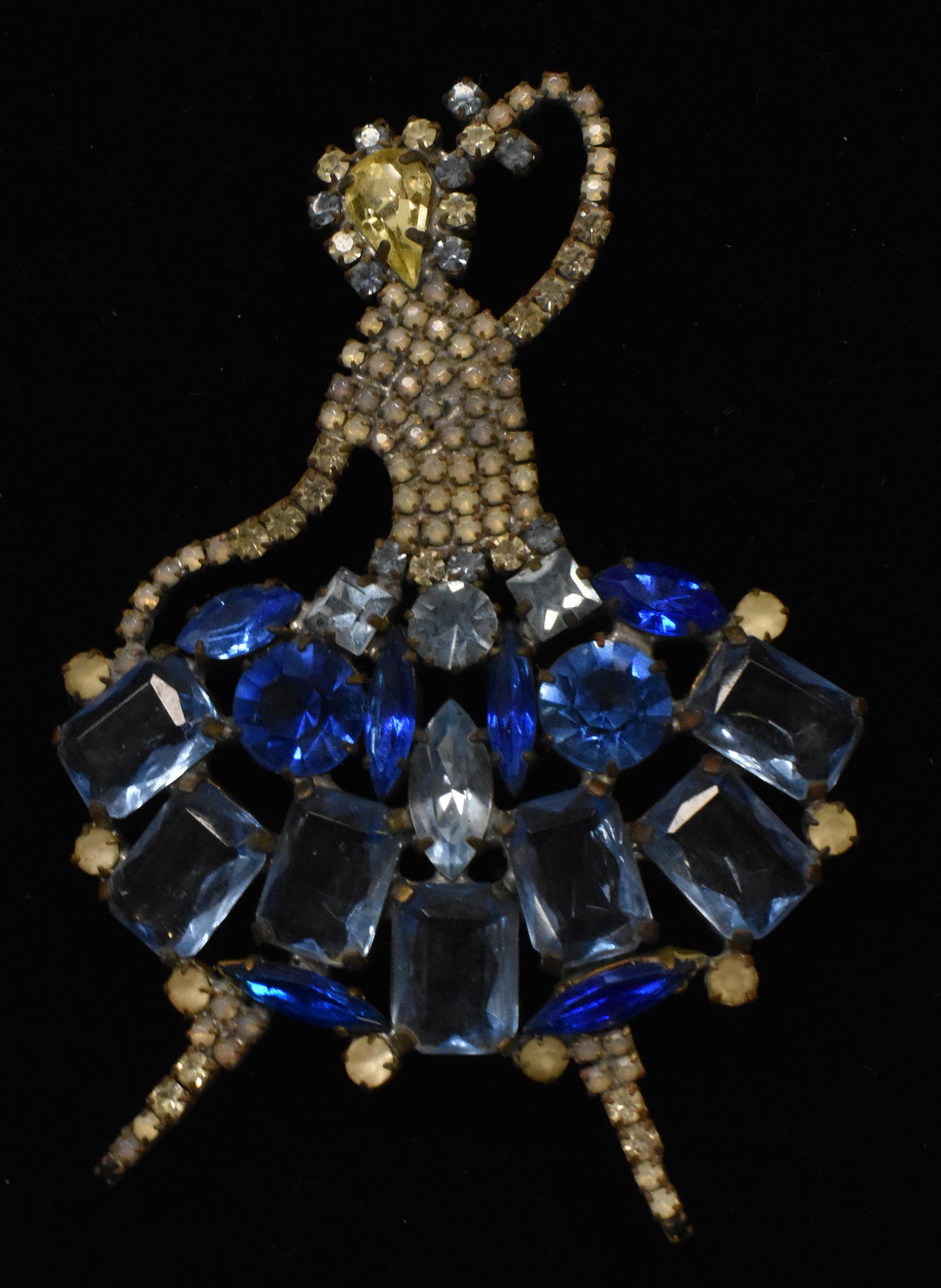 Large Czech Ballerina Brooch: Measures approx. 4"h. It has blue, yellow and clear rhinestones. Brooch has a brass body and is marked "Czech".