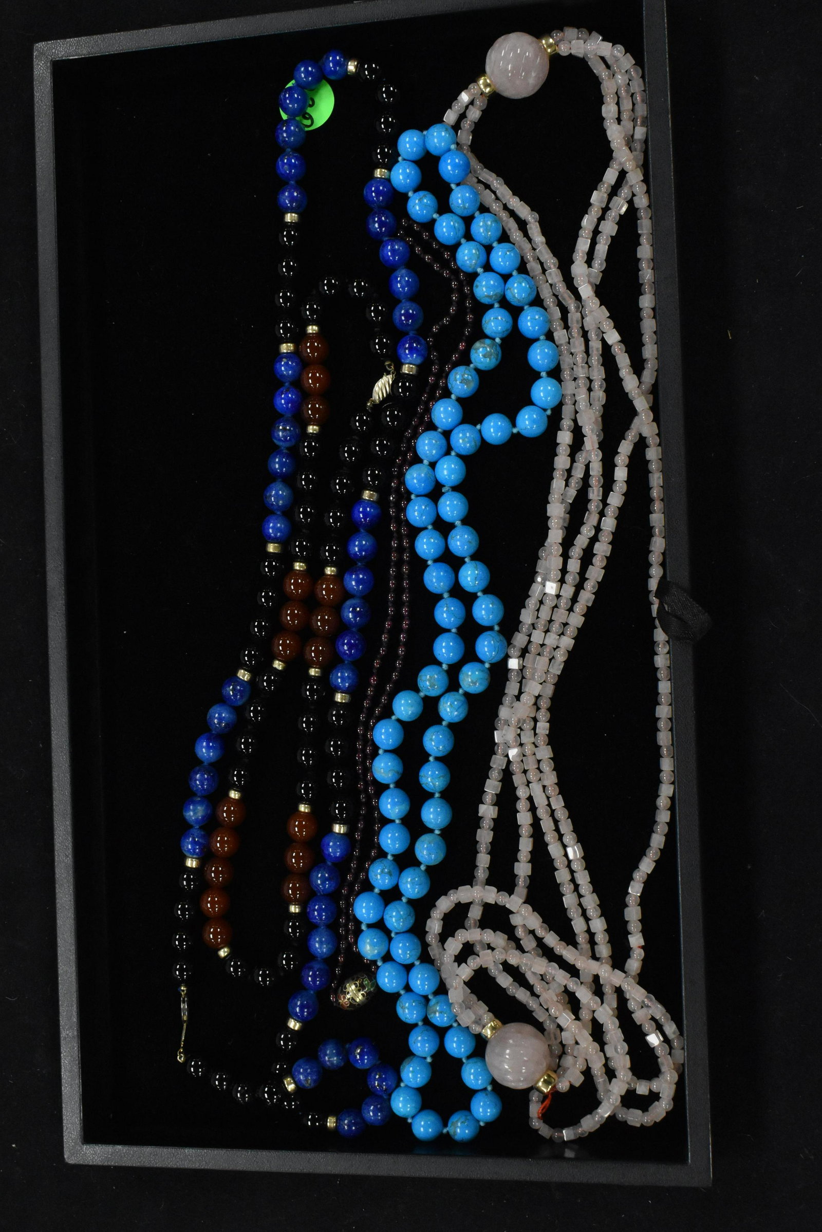 Stone Necklace Collection: Five necklaces including two lapis and carnelian necklaces, a rose quartz necklace, a turquoise necklace and a burgundy beaded necklace.