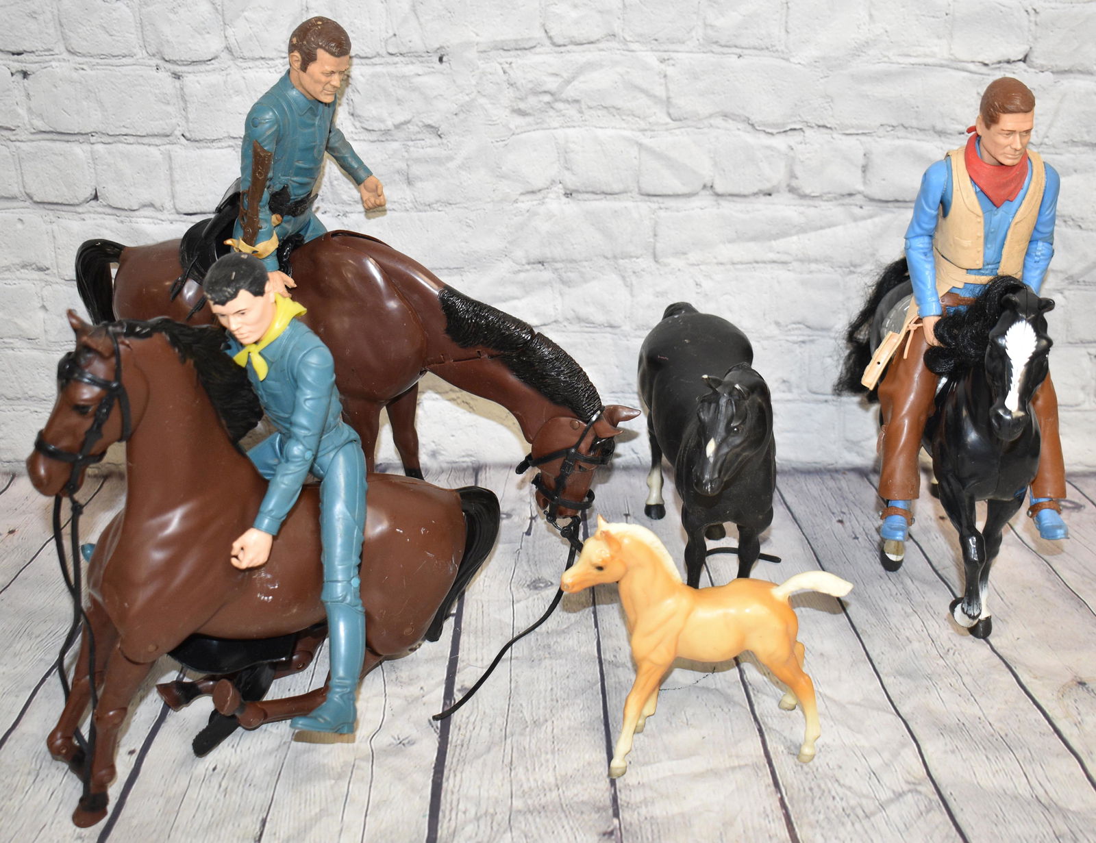 Marx Johnny West Figures and Horses: Three Johnny West series cowboys, two Marx horses with adjustable heads, two black horses and a colt from an unknown maker.