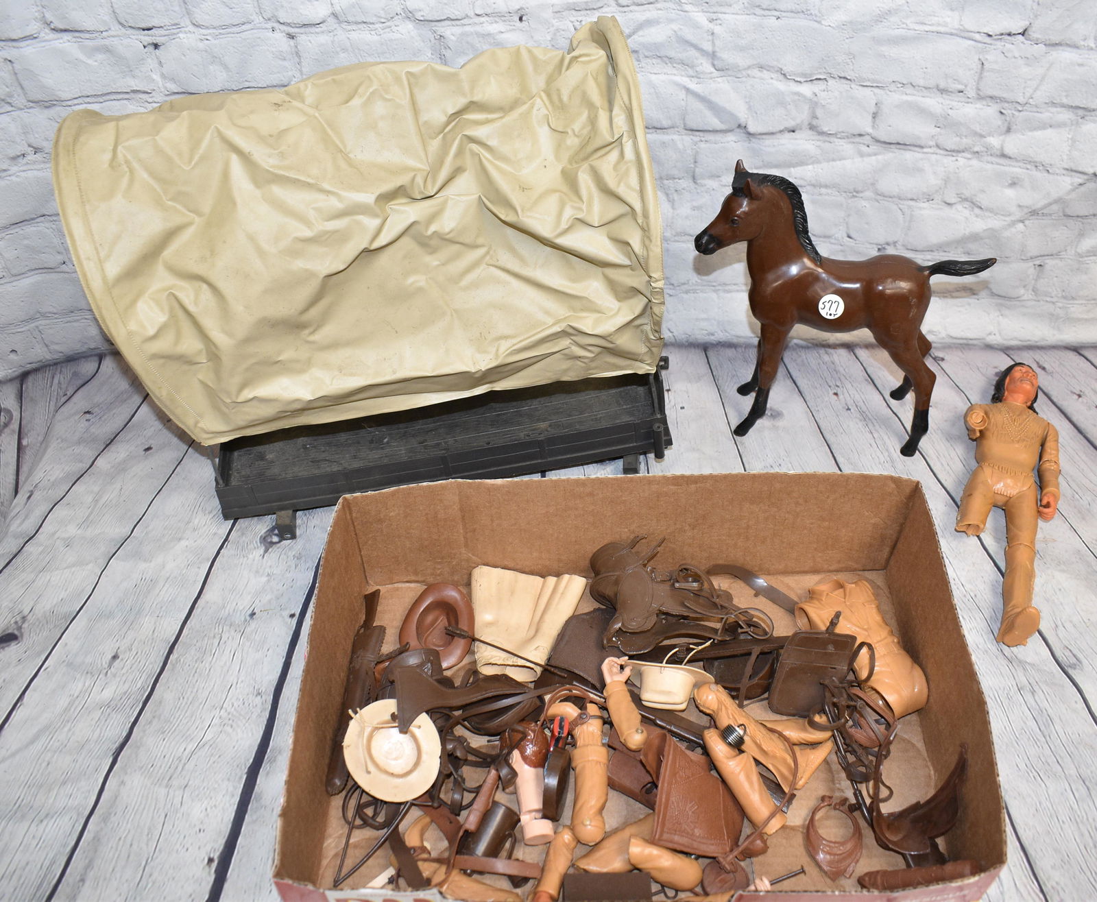 Marx Johnny West Accessories and Parts: Including rifles, saddles, hats and other accessories. Lot also includes wagon parts, body parts and a Marx colt