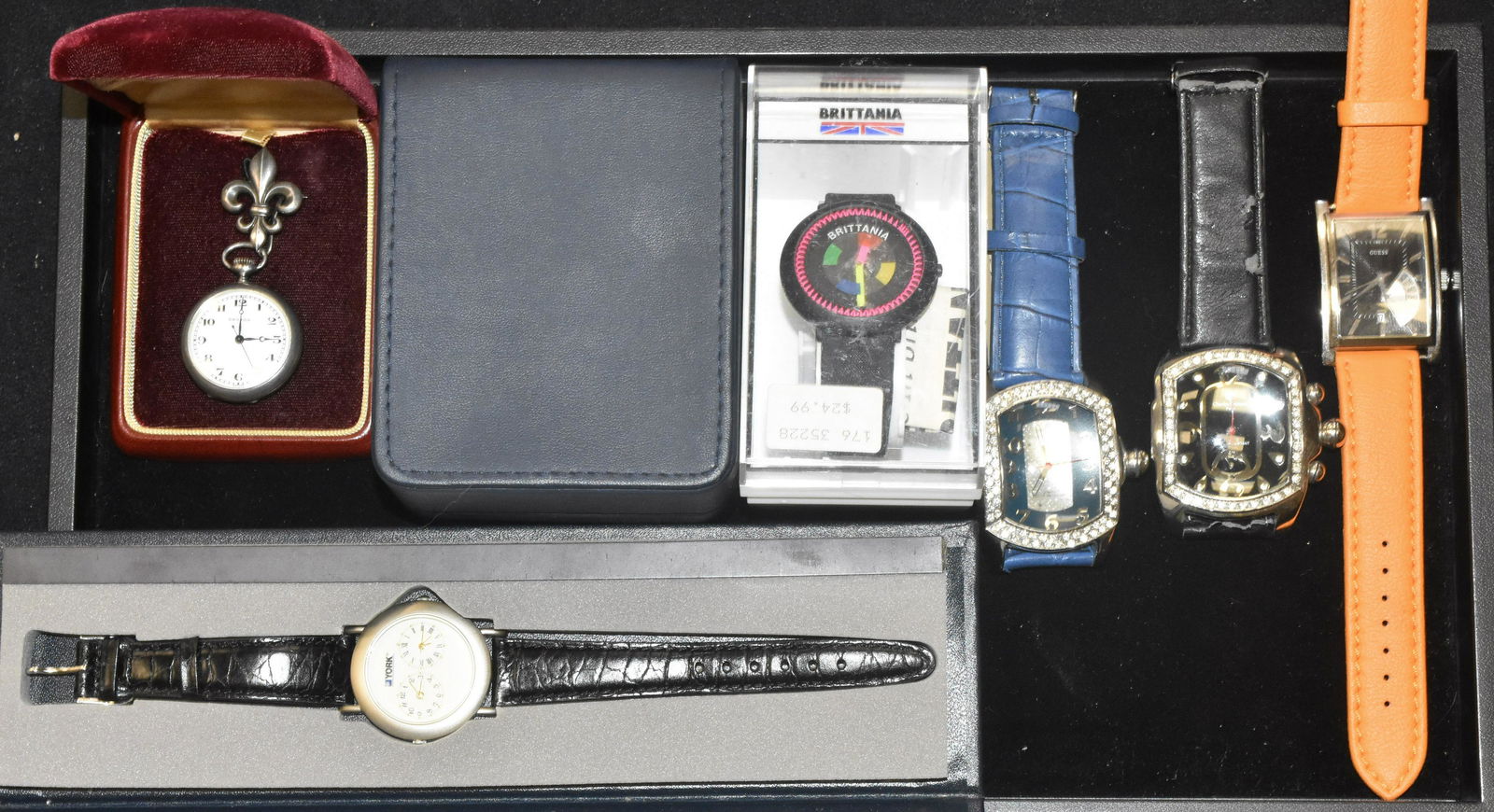 Grouping of Watches: Including a "Tommy Boy" watch in box, a Croton pocket watch with a fleur de lis, two Charles Dumont watches a Guess watch with day, a York International two face watch and a colorful Britannia watch.