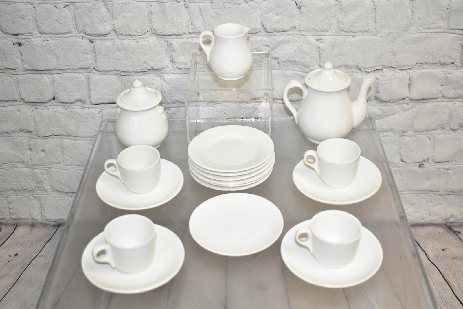 Miniature White Ironstone Tea Set: Includes a teapot measuring approx. 4 1/2"h, a sugar and creamer (sugar has minor flakes). four cups and saucers and six under plates.