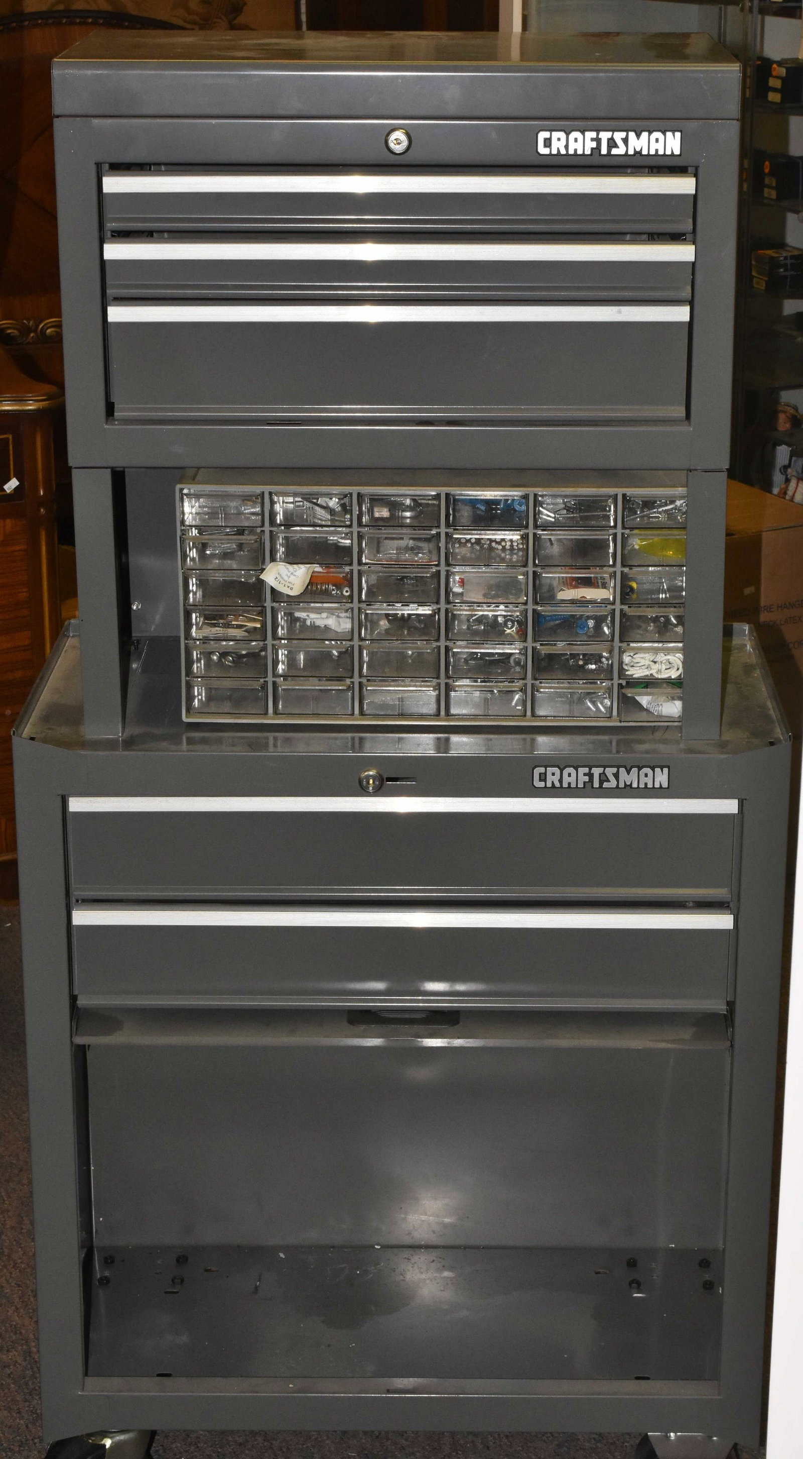 Craftsman Two Tier Toolbox on Rollers: Measuring 55" high x 27" wide x 14" deep. With keys and some small items contents.