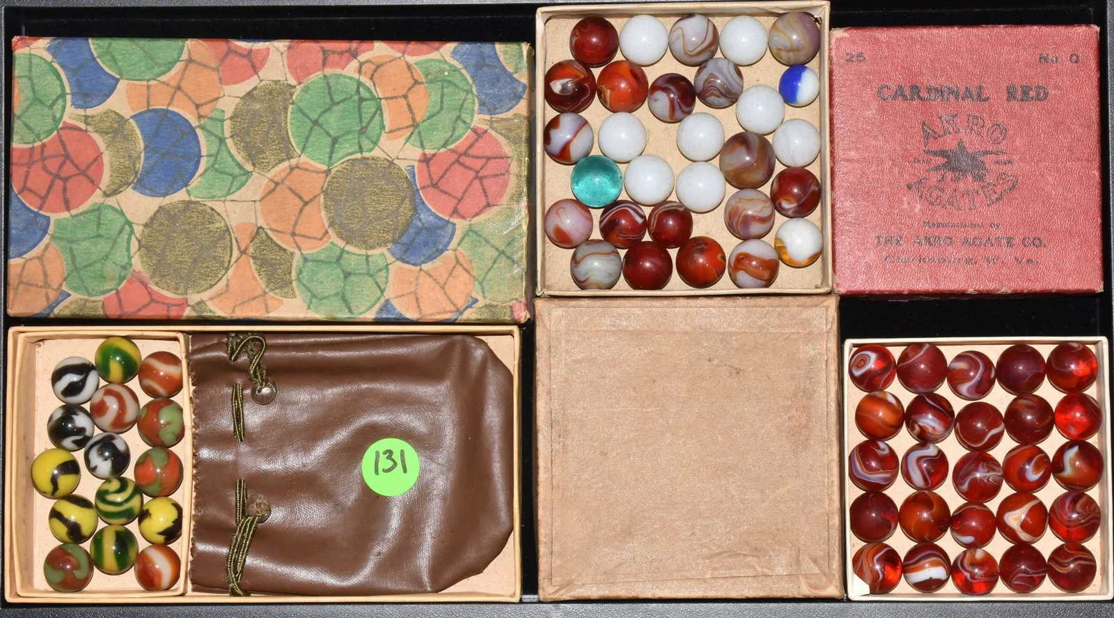 Akro Agate Cardinal Red Marbles and other Sets: Including Cardinal Red Marble set #0 in original red box, a set of fifteen marbles with bag in original box and a grouping of Cardinal Red and other marbles in a box.