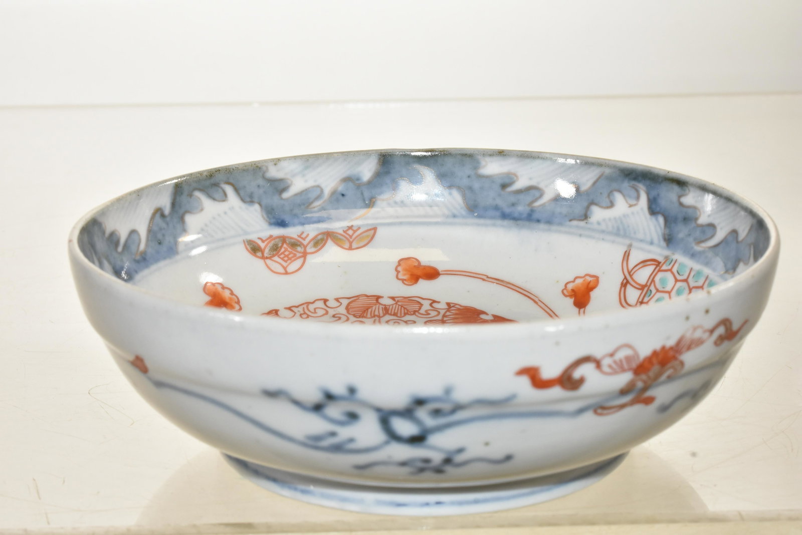 Early Chinese Low Bowl: Measures approx. 6"dia. It has a multi colored hand painted decoration on inside and outside and a blue ring mark on bottom.