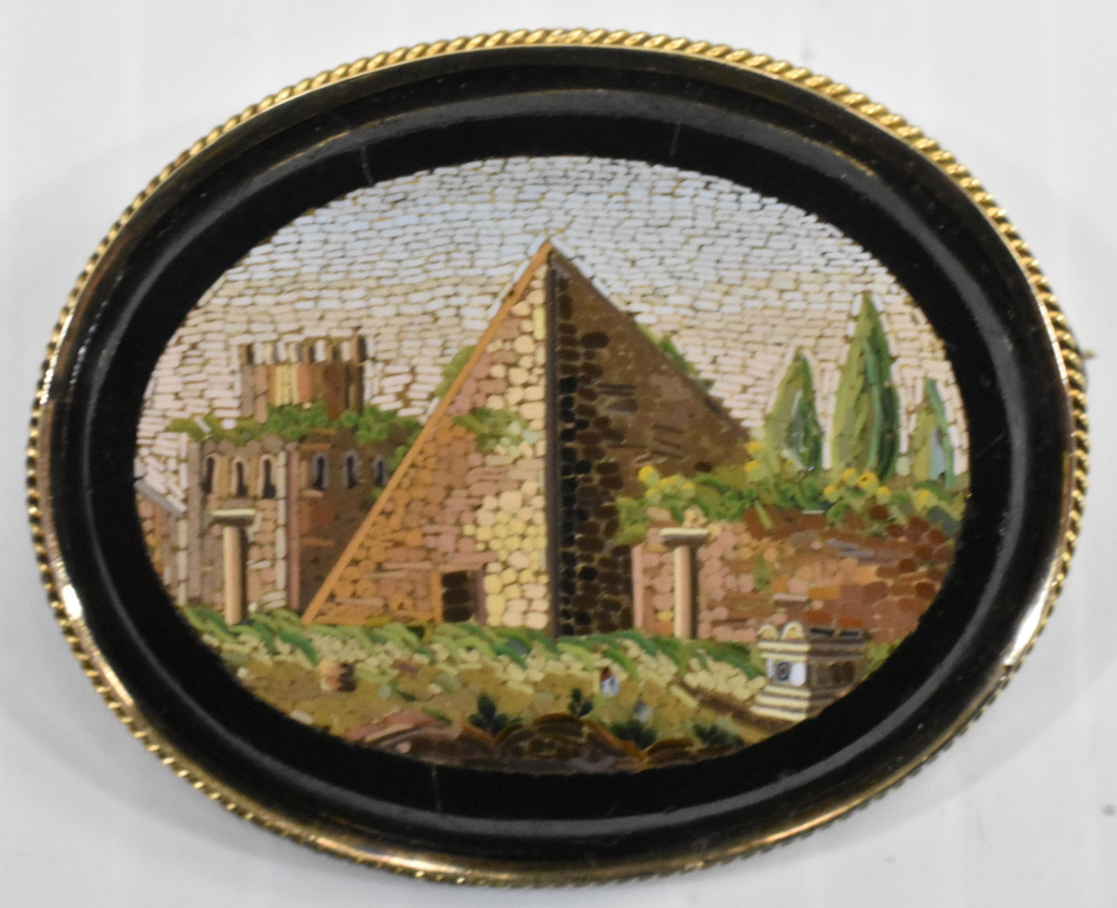 Victorian Micro Mosaic Brooch: Extra fine micro mosaic of a pyramid and greenery with other buildings. Brooch is set in a gold frame and catch on the pin bar has been replaced.