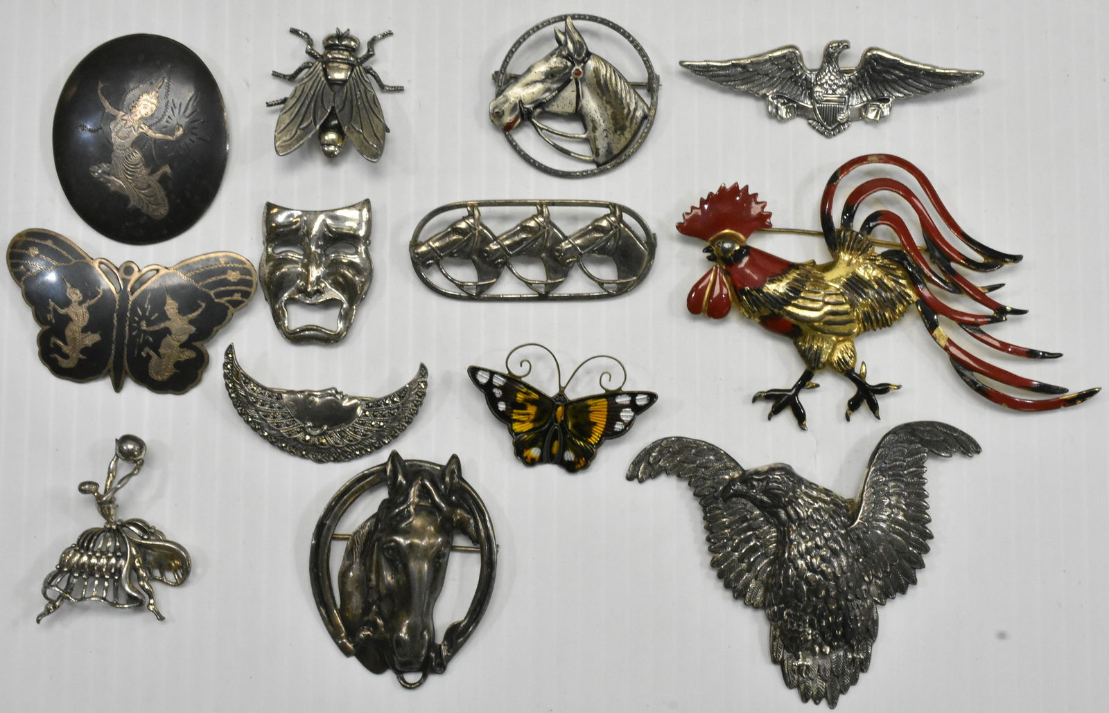 Vintage Figural Sterling Pin Collection: Including a 1920's enameled rooster pin, a David Anderson enameled butterfly, a large eagle pin, two Siam pins, horse pins, a ballerina, a fly pin and more. Some signed "Danecraft" an some signed "Bea